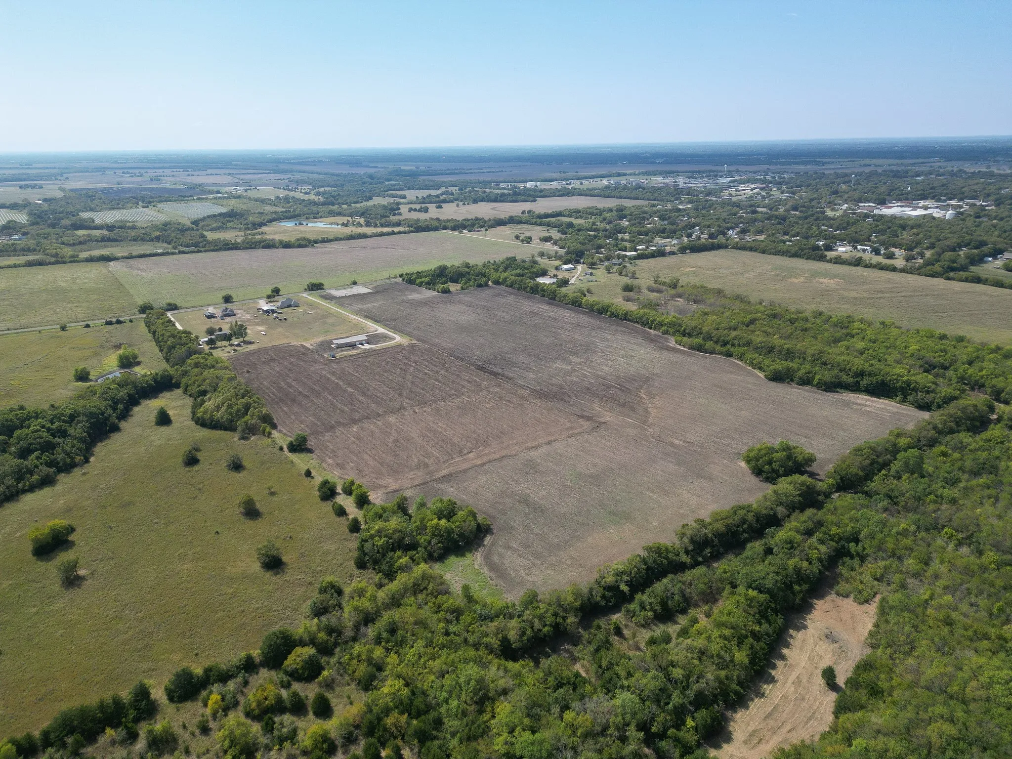 Aerial view of property's location with rural landscape and farmland