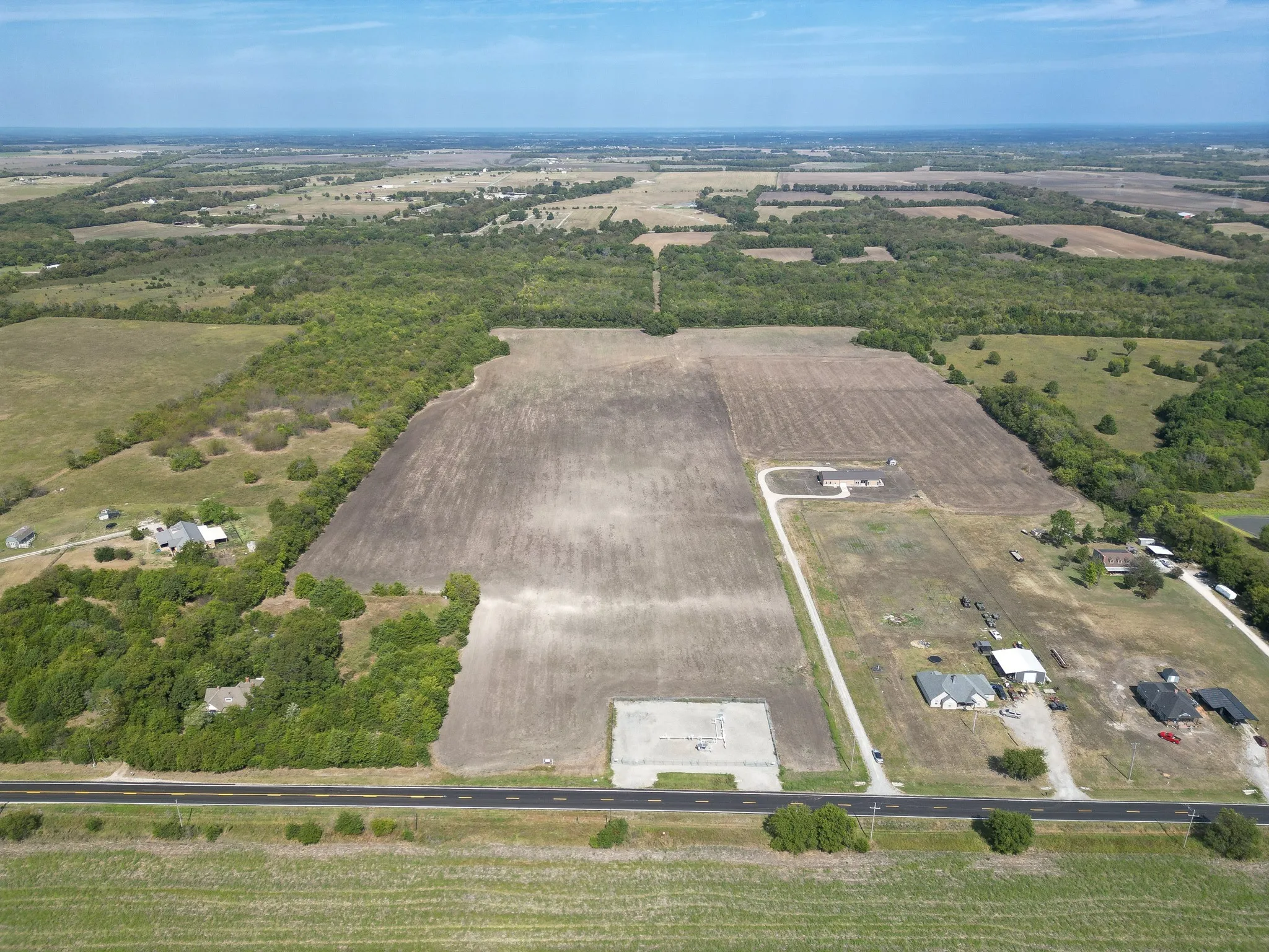 Aerial overview of property's location with rural landscape and abundant farmland
