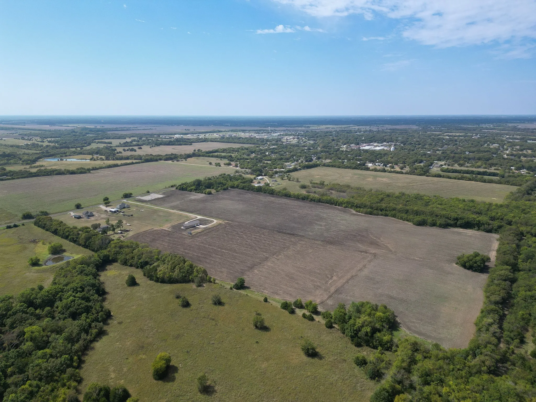 Aerial view of property's location with rural landscape and farmland