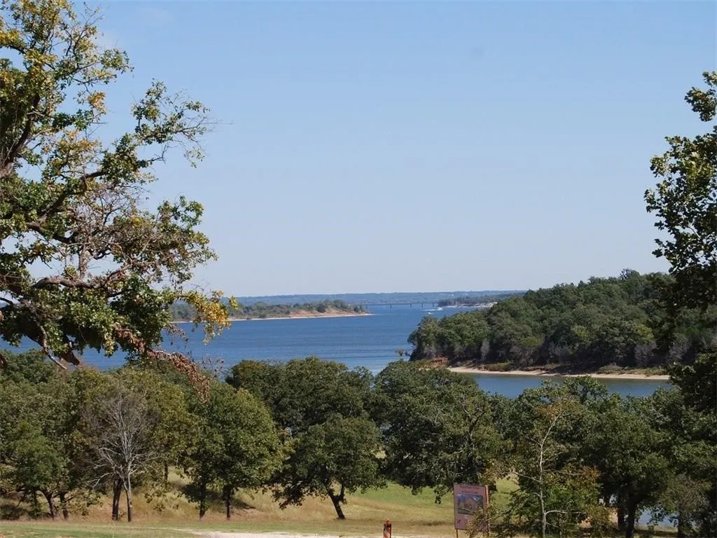 Water view featuring a heavily wooded area