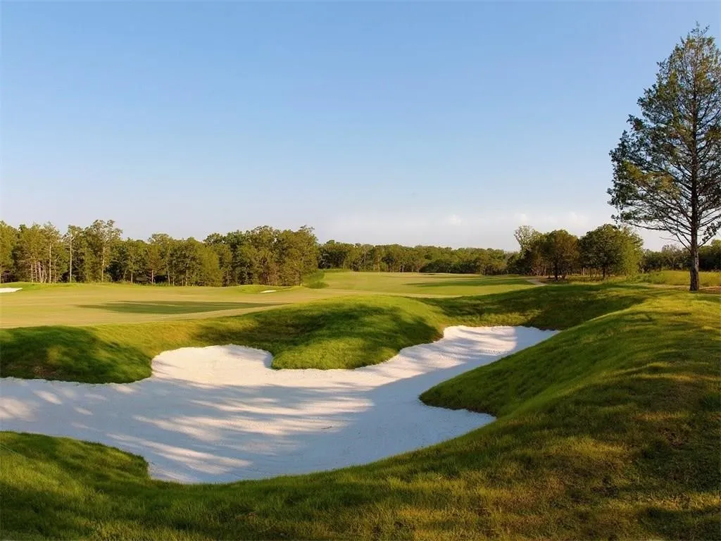 View of property's community featuring view of golf course and a lawn