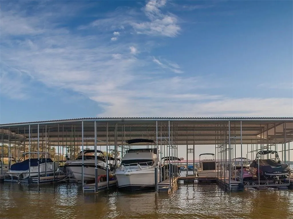 Dock area featuring a water view and boat lift