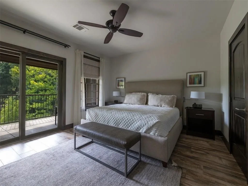 Bedroom featuring access to exterior, dark wood finished floors, and ceiling fan