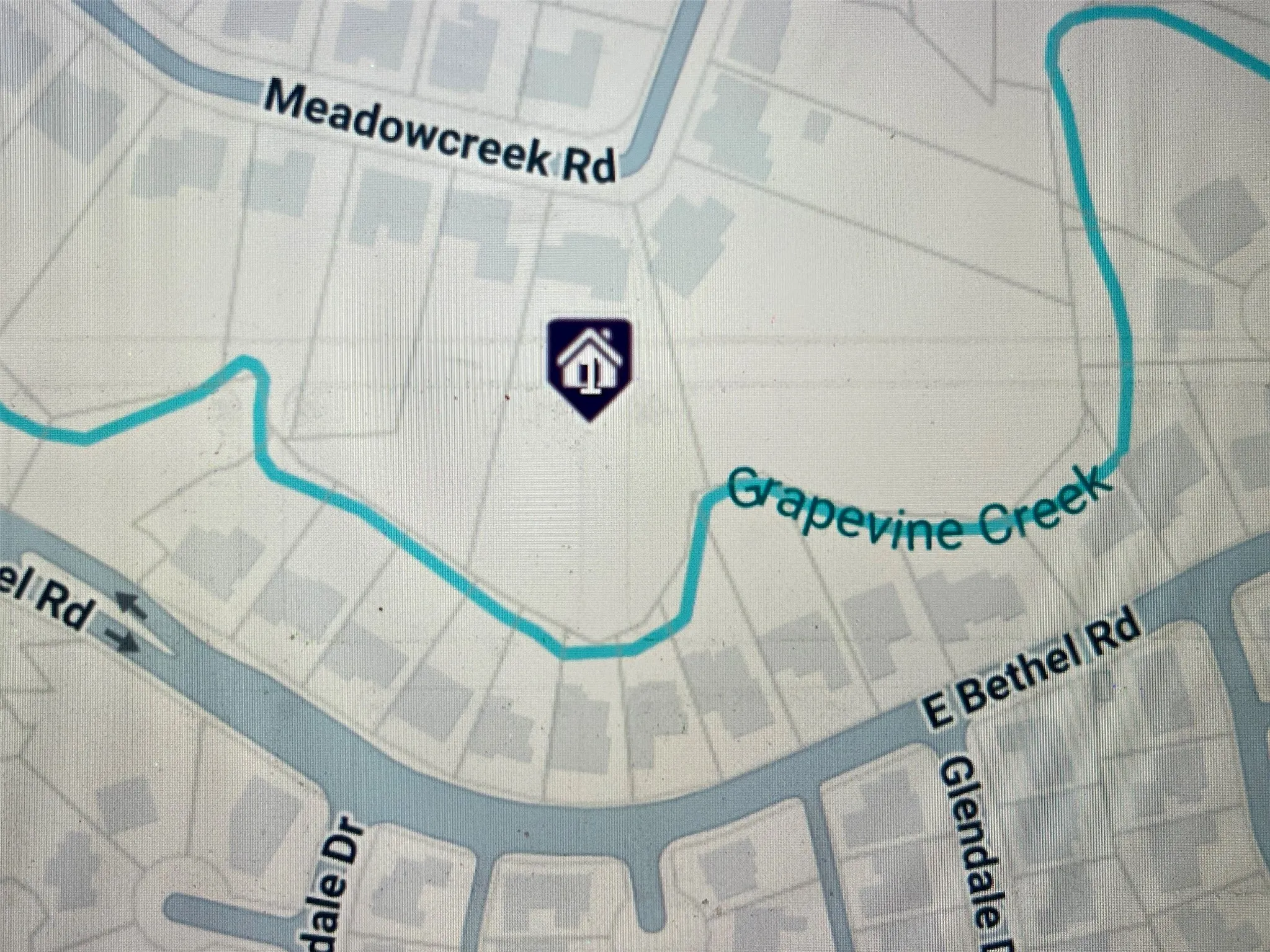 Beautiful Grapevine Creek runs along back of this pie-shaped property