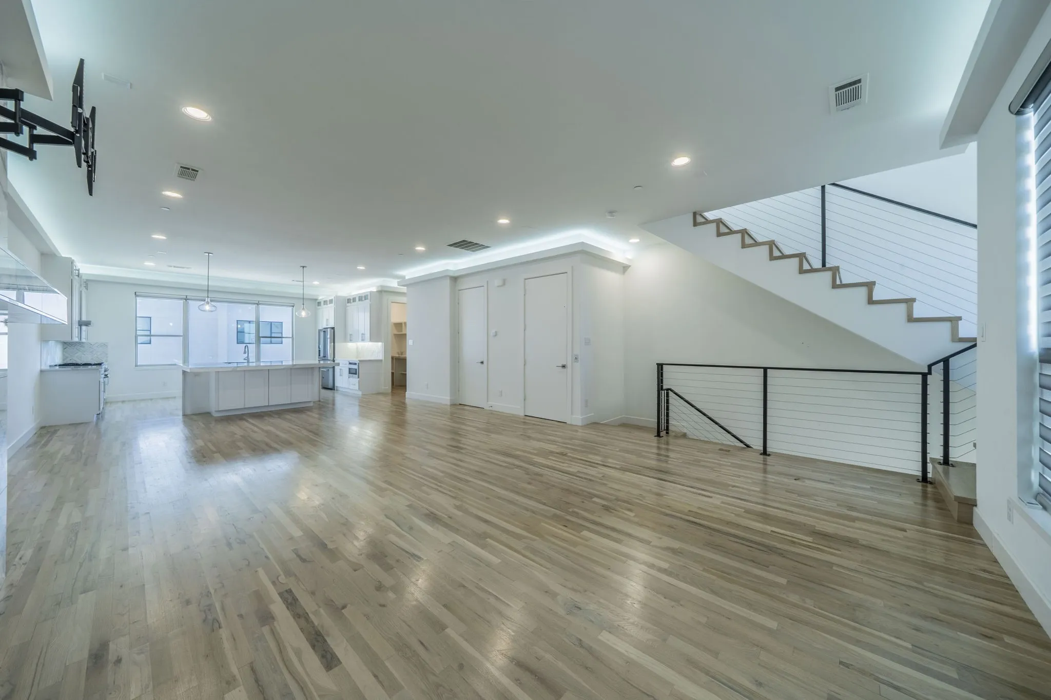  living room featuring light wood-style floors, recessed lighting, and stairway