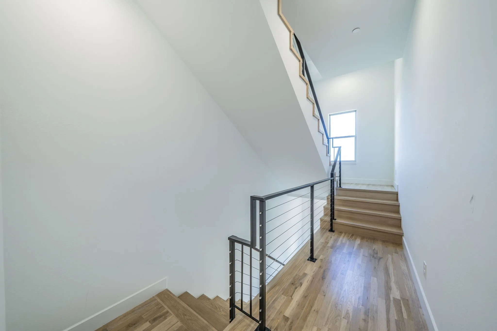 Stairway featuring wood finished floors and baseboards