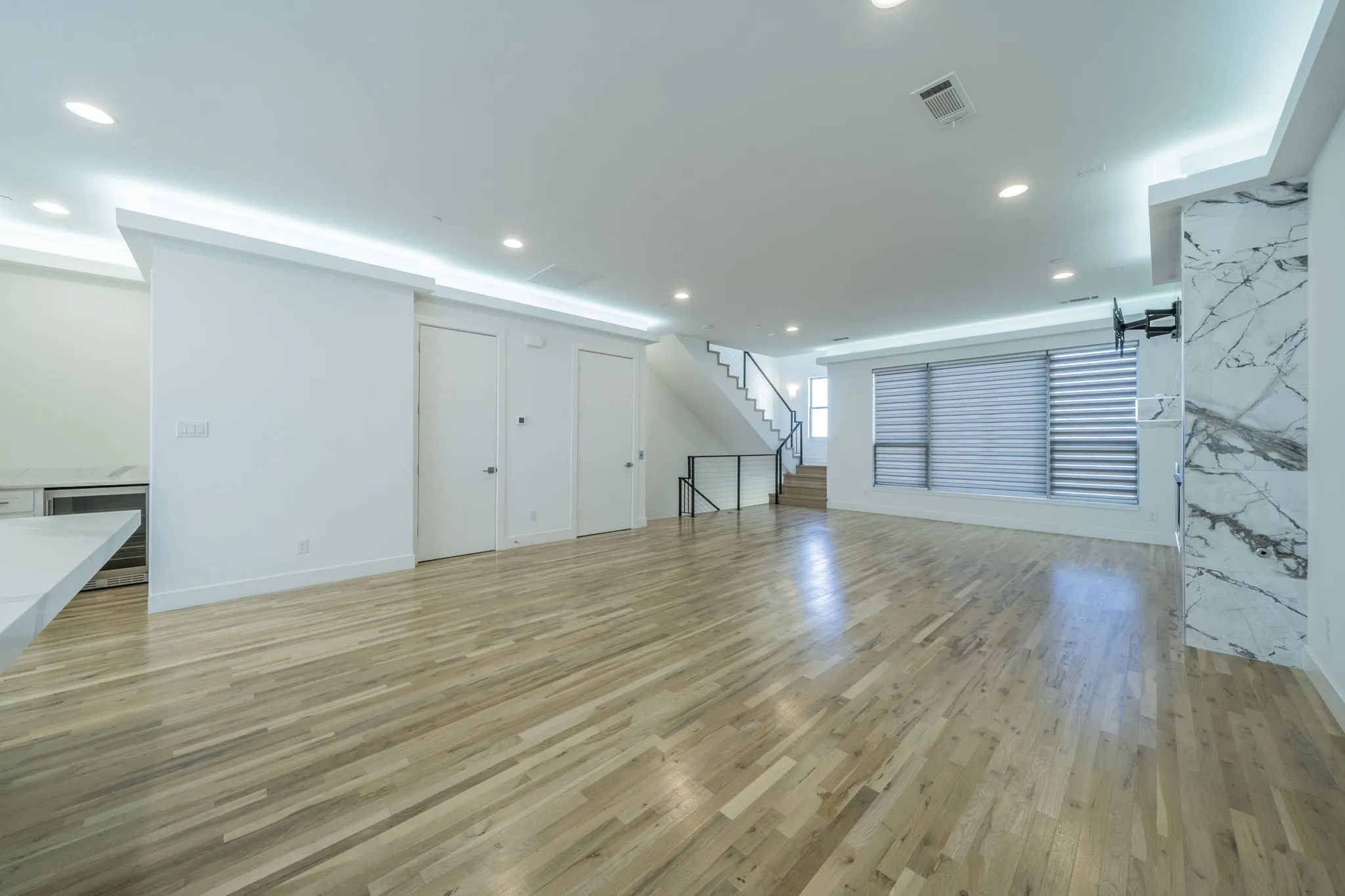  living room with stairway, light wood-style flooring, recessed lighting, and wine cooler