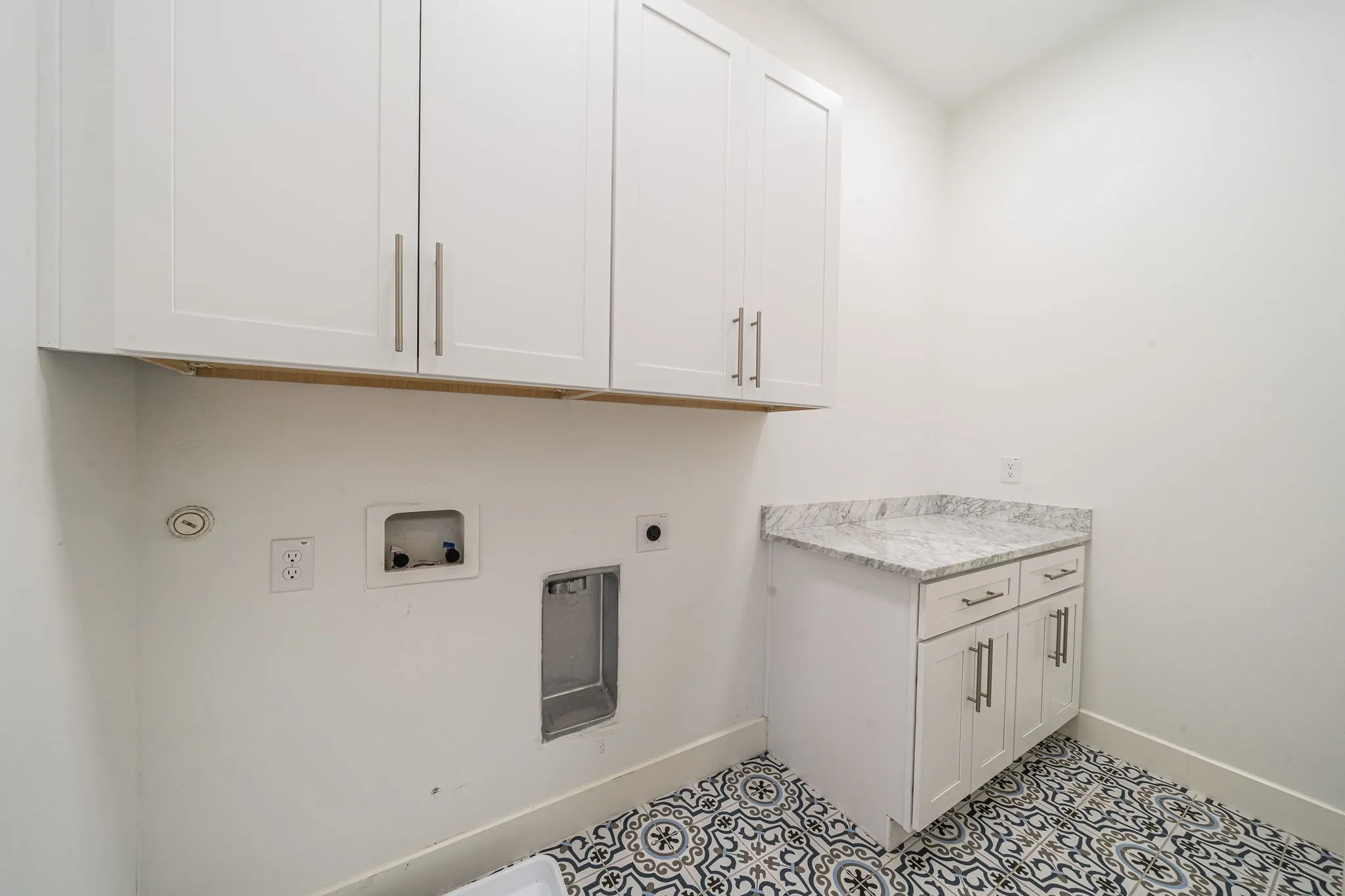 Laundry area with cabinet space, hookup for an electric dryer, and hookup for a washing machine