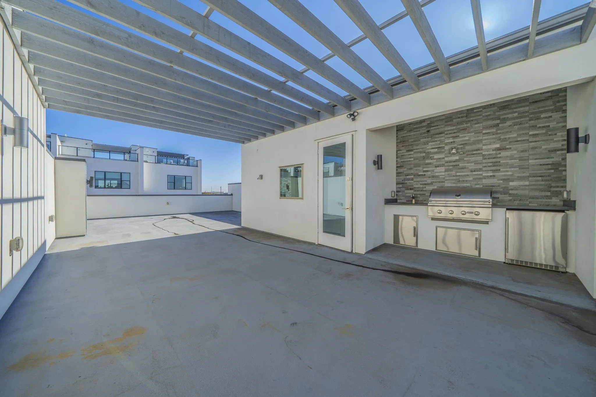 View of patio / terrace featuring exterior kitchen and a pergola and fireplace