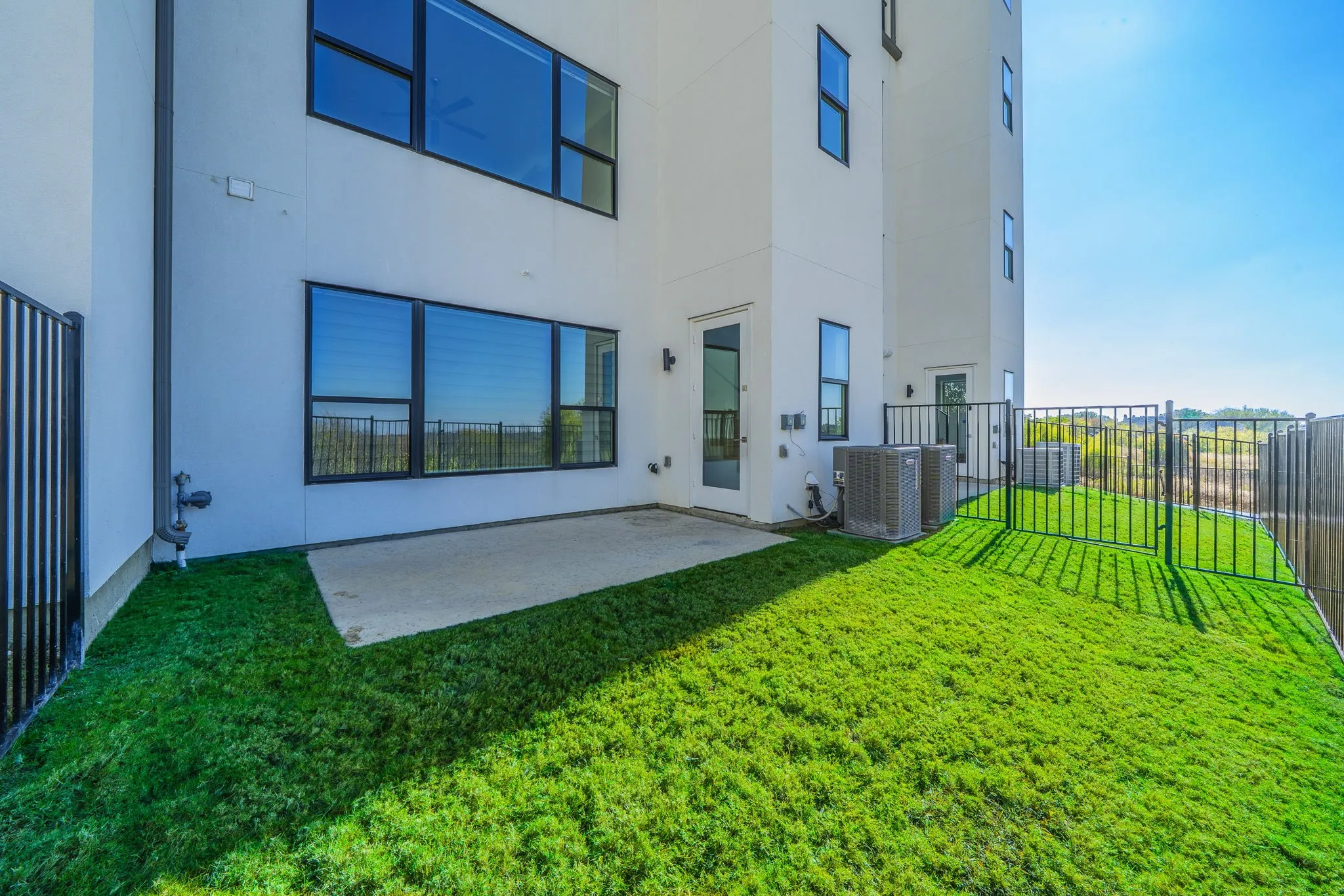Rear view of property featuring a fenced backyard, stucco siding, and a patio area
