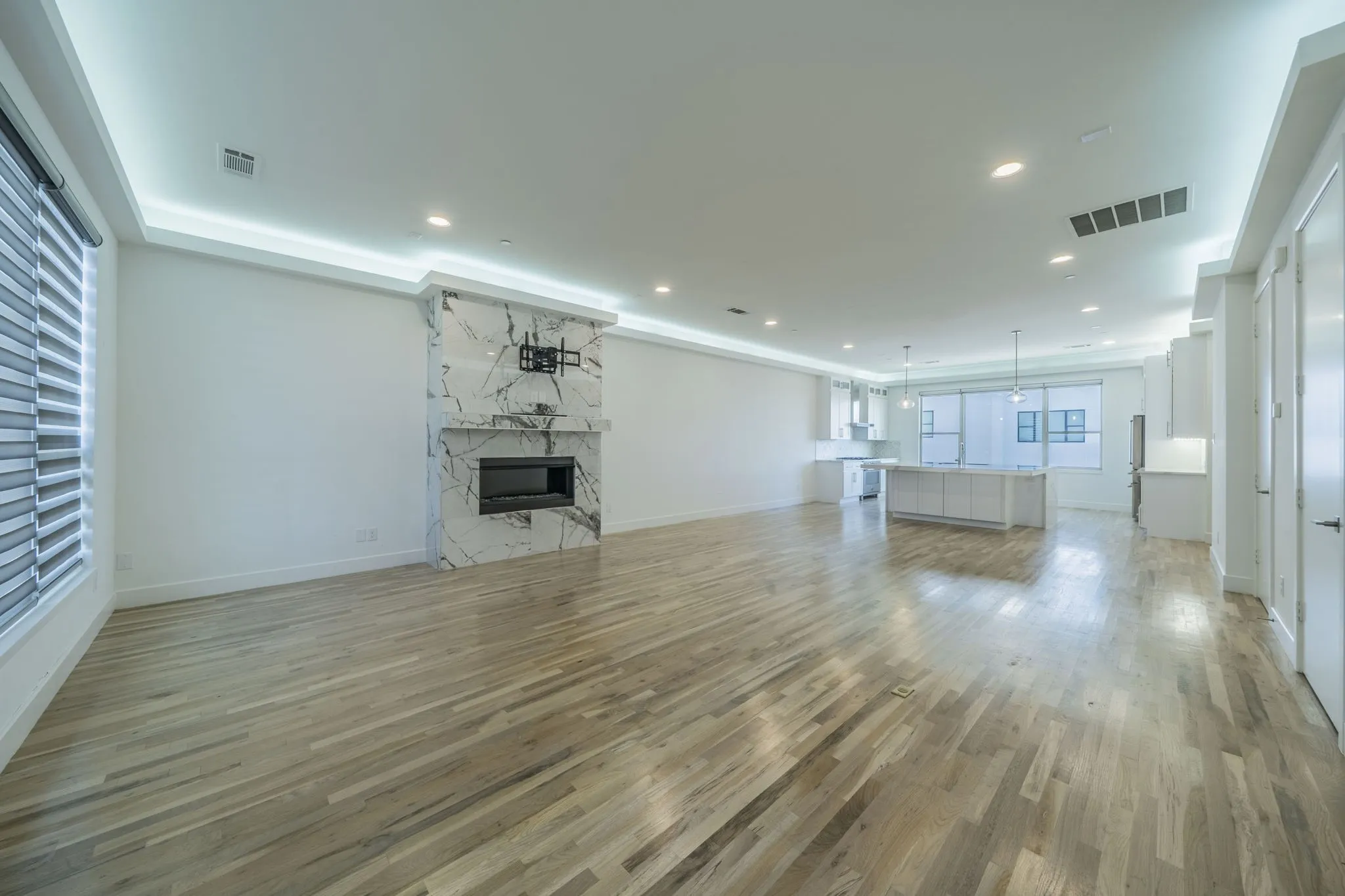 living room with light wood-type flooring, a premium fireplace, and recessed lighting and fireplace