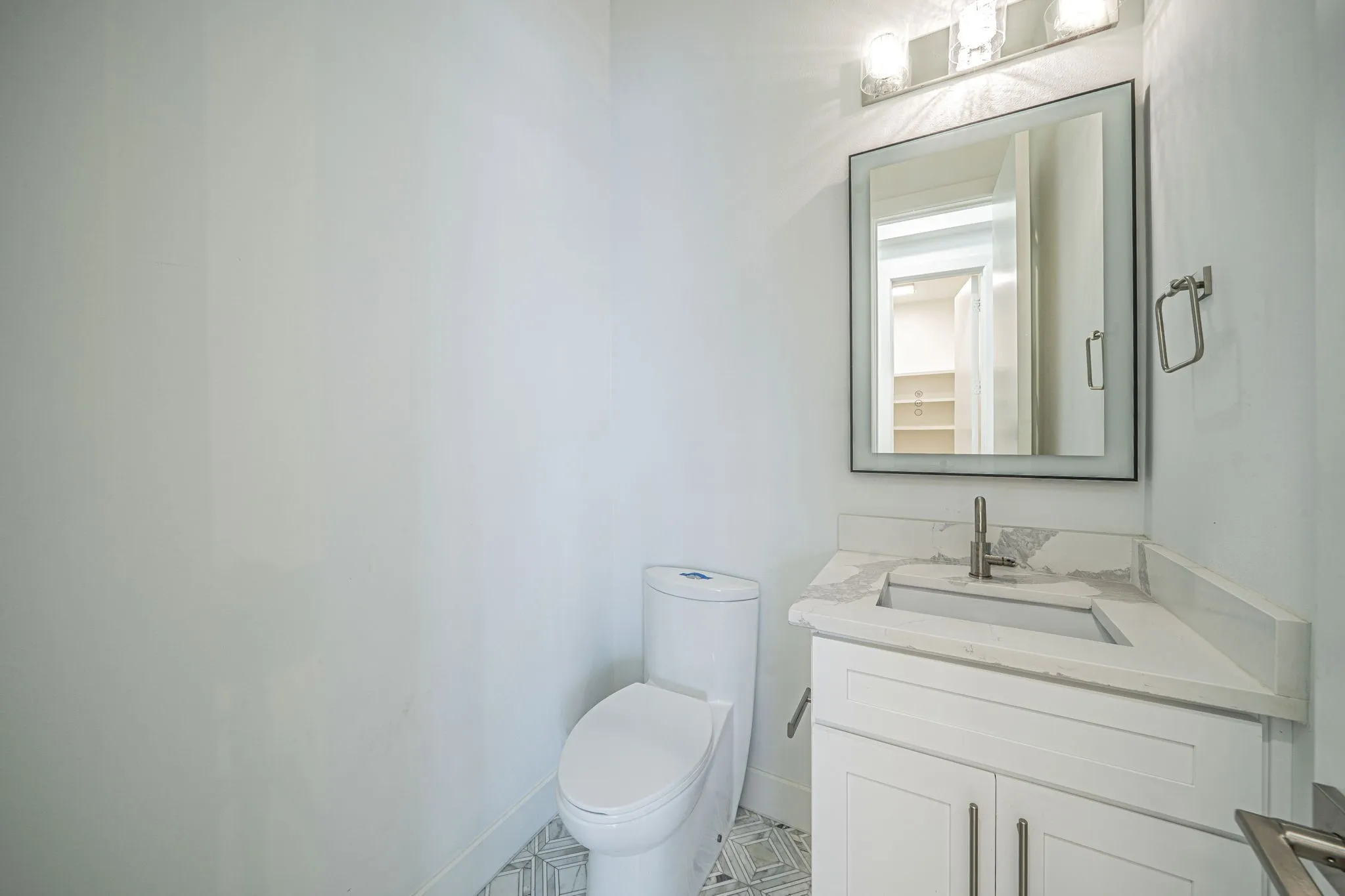 Half bath with vanity and toilet. 3rd level bath by Living area