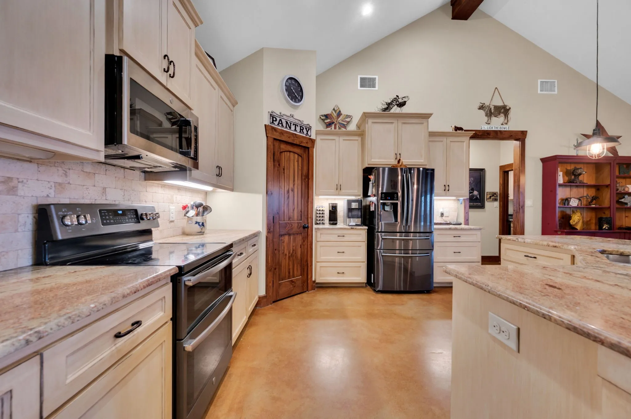 Beautiful custom kitchen with granite counters. Big pantry and a second pantry closet is in laundry room.
