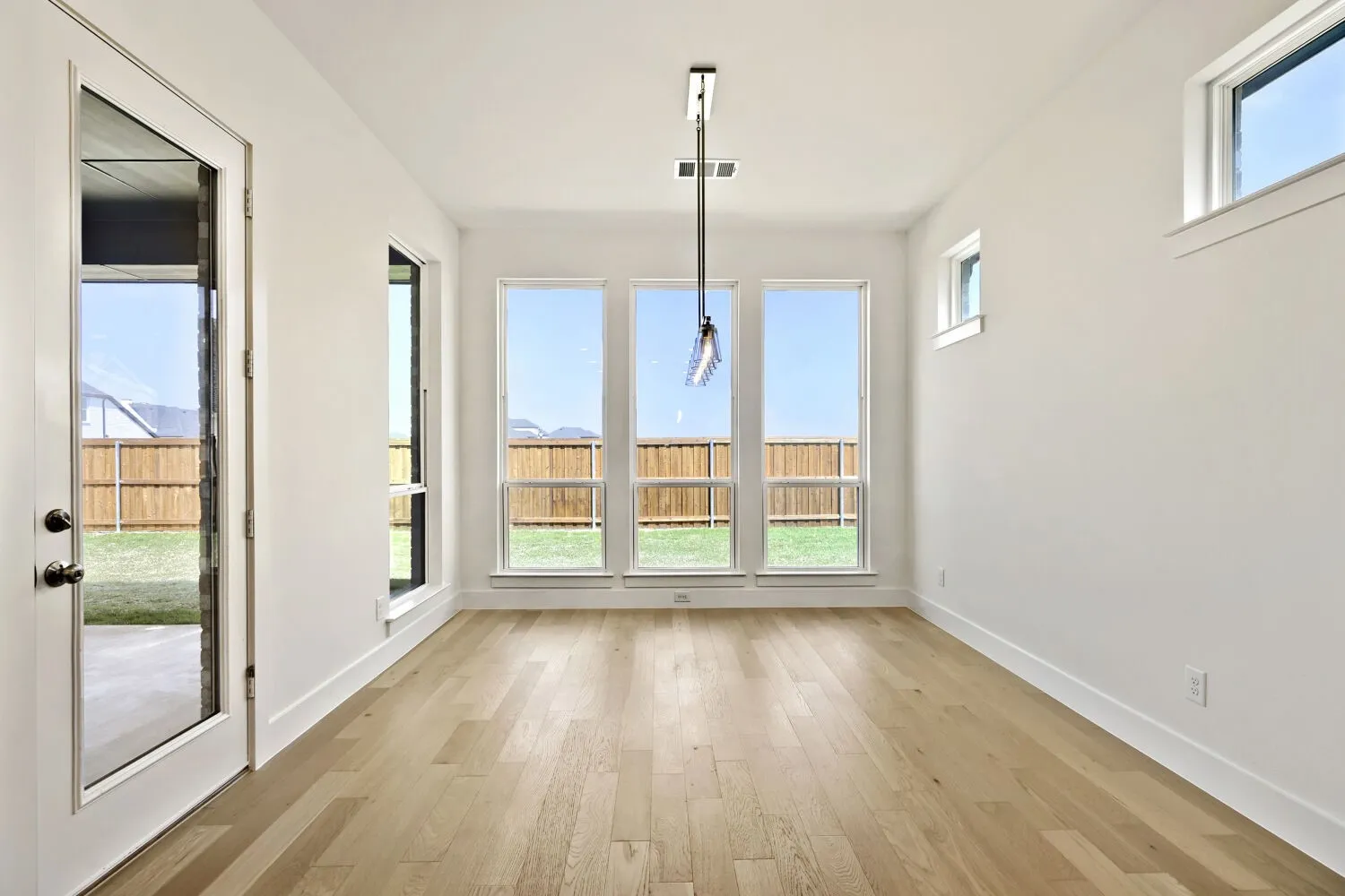 Unfurnished dining area featuring light wood-style floors and baseboards