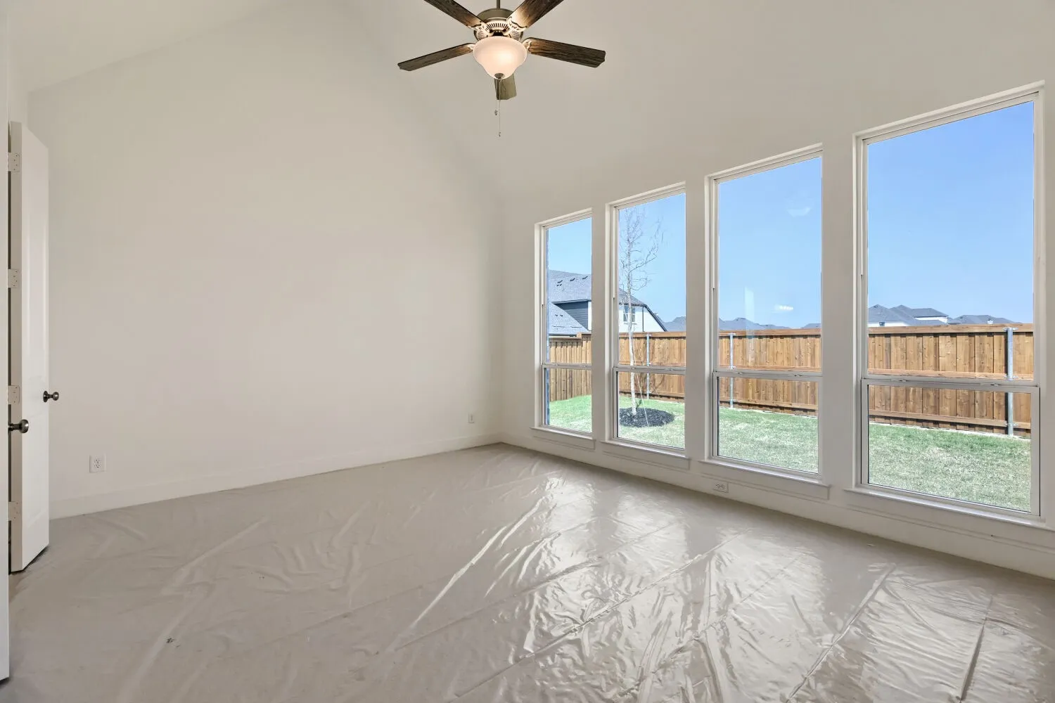Spare room featuring ceiling fan and lofted ceiling