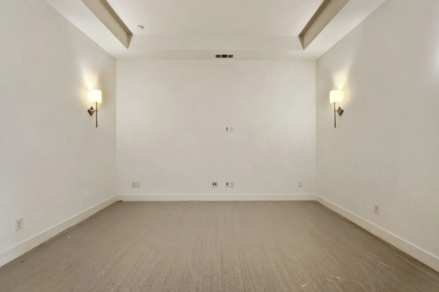 Empty room with a raised ceiling and baseboards