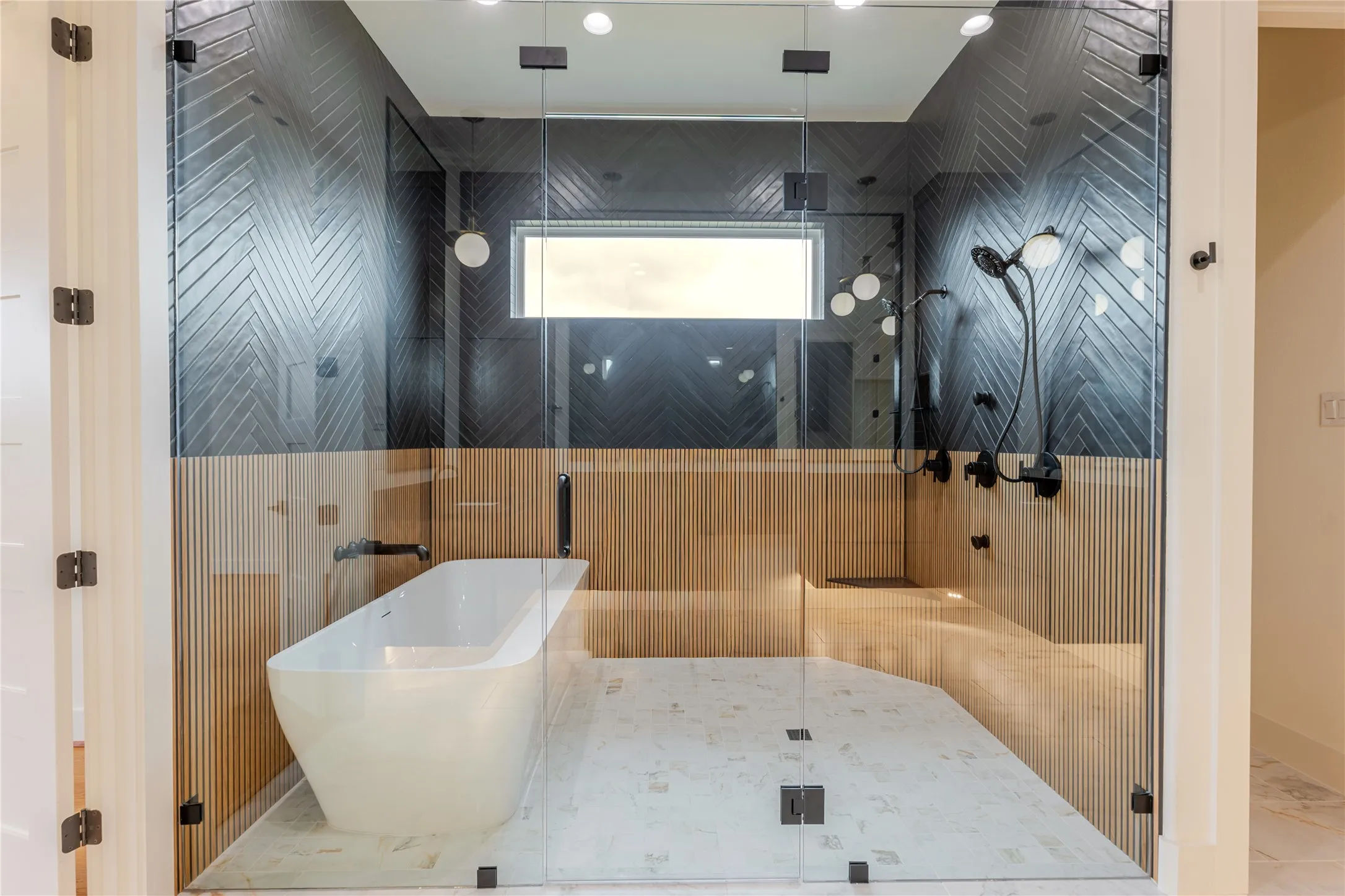 Full bath featuring a freestanding tub, a stall shower, and marble finish floors