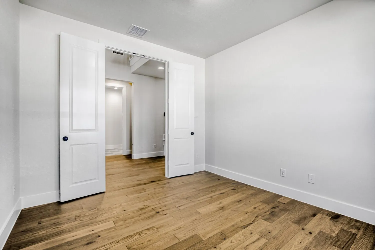 Unfurnished bedroom featuring light wood-style floors and baseboards