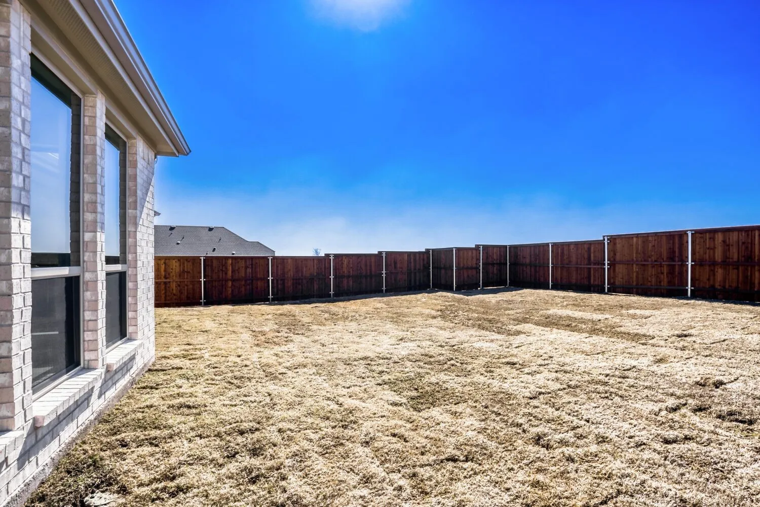 View of fenced backyard