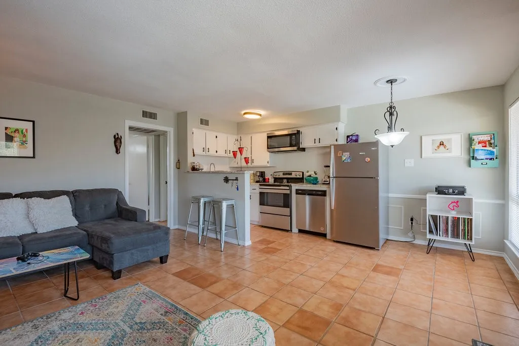 Living area featuring light tile patterned floors