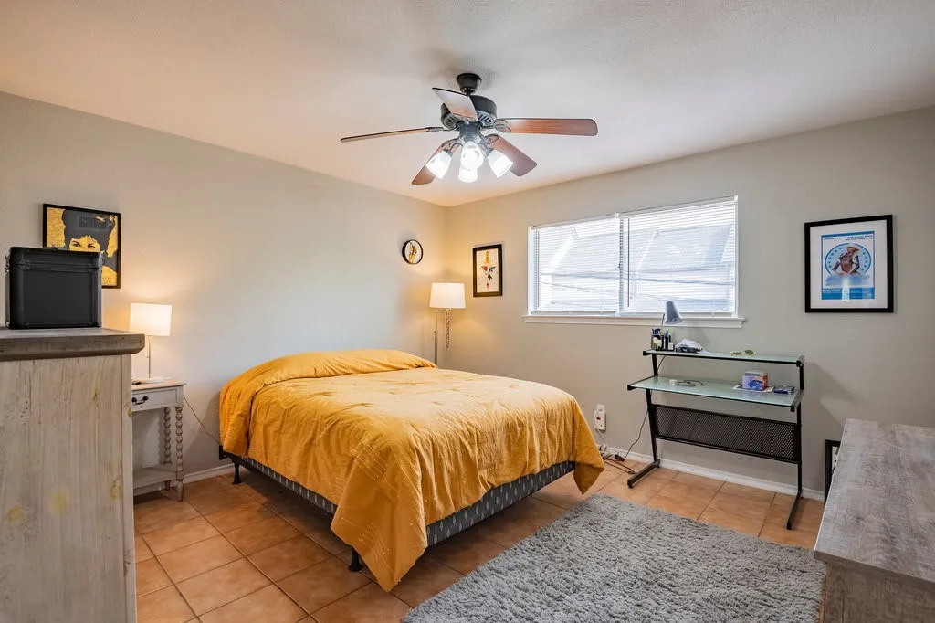 Bedroom featuring light tile patterned flooring and a ceiling fan