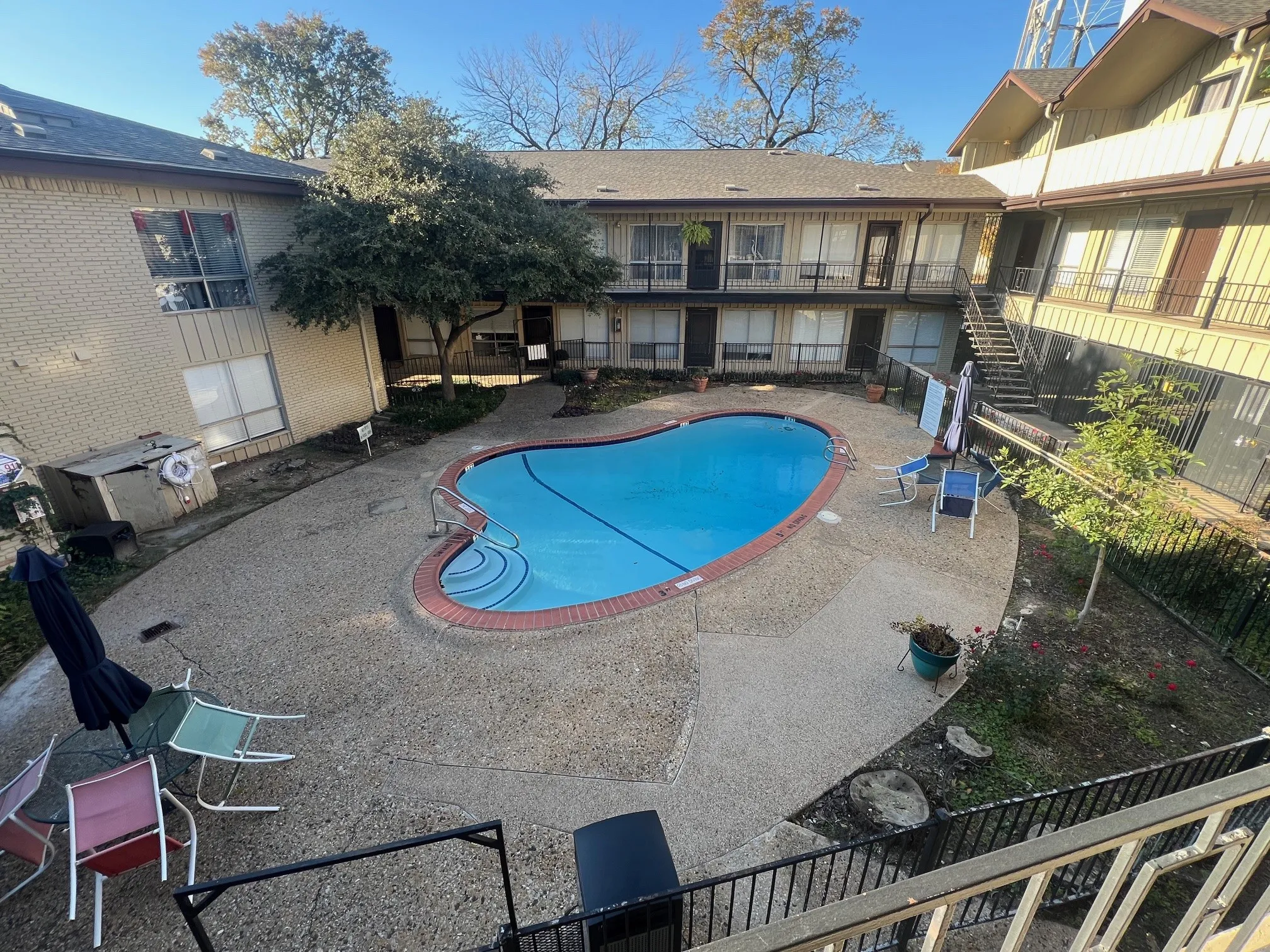 Community pool with stairway, a patio, and a balcony