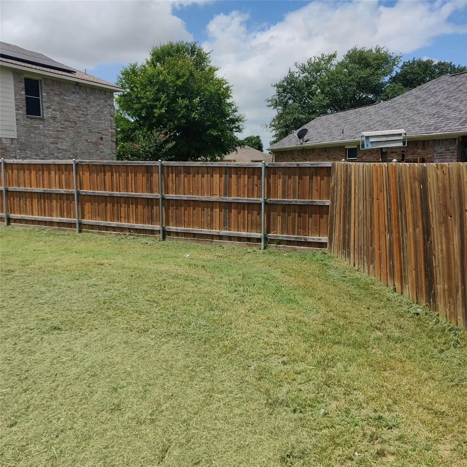 View of fenced backyard