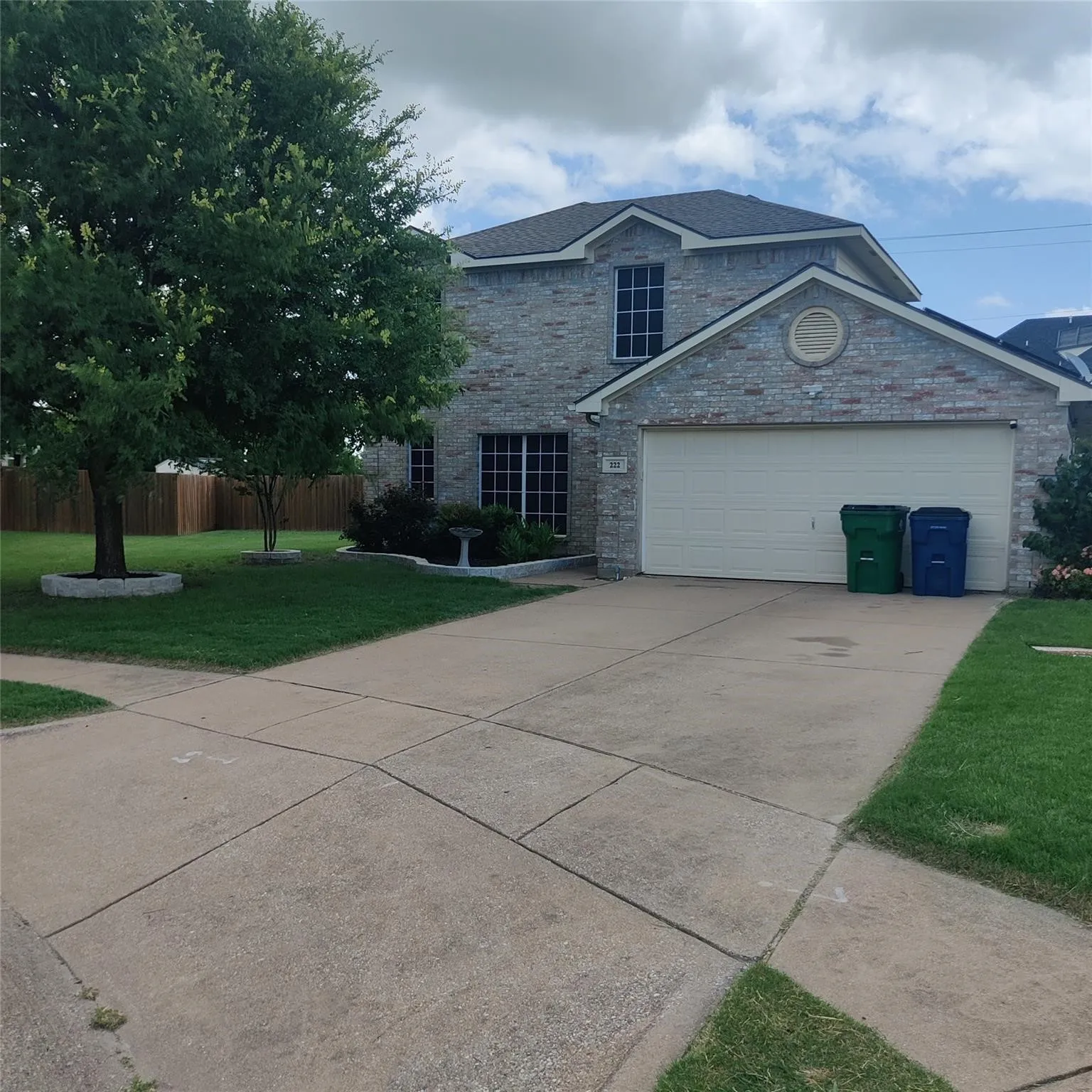 Traditional-style home with concrete driveway and an attached garage