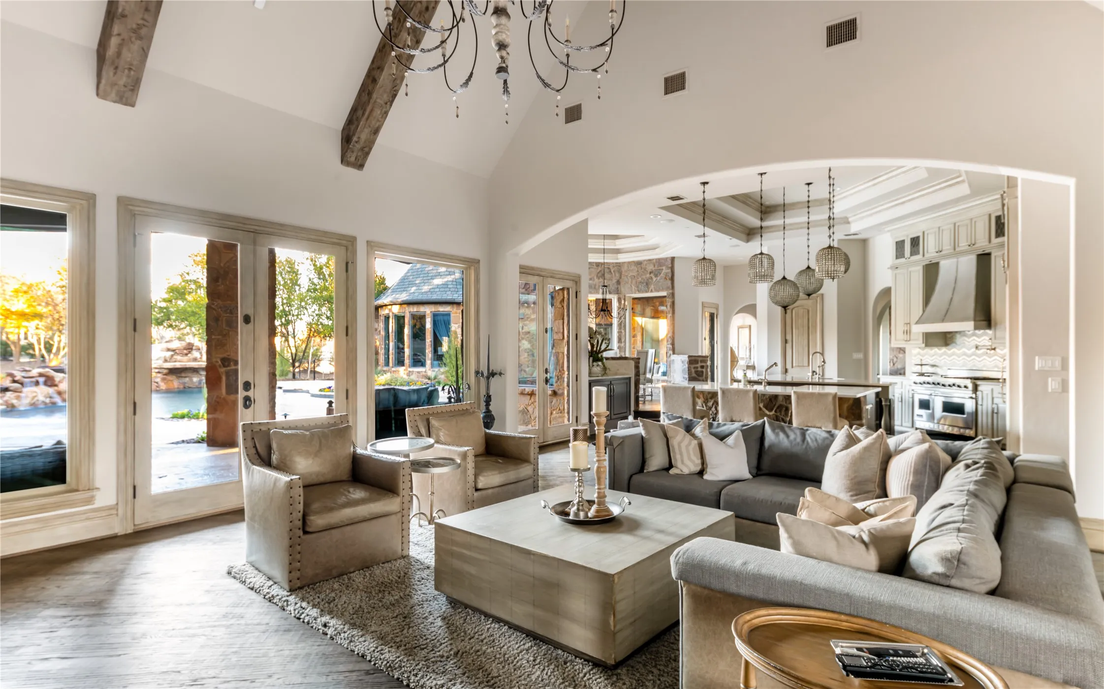 Living room is open to the kitchen, tall ceilings with wood beams