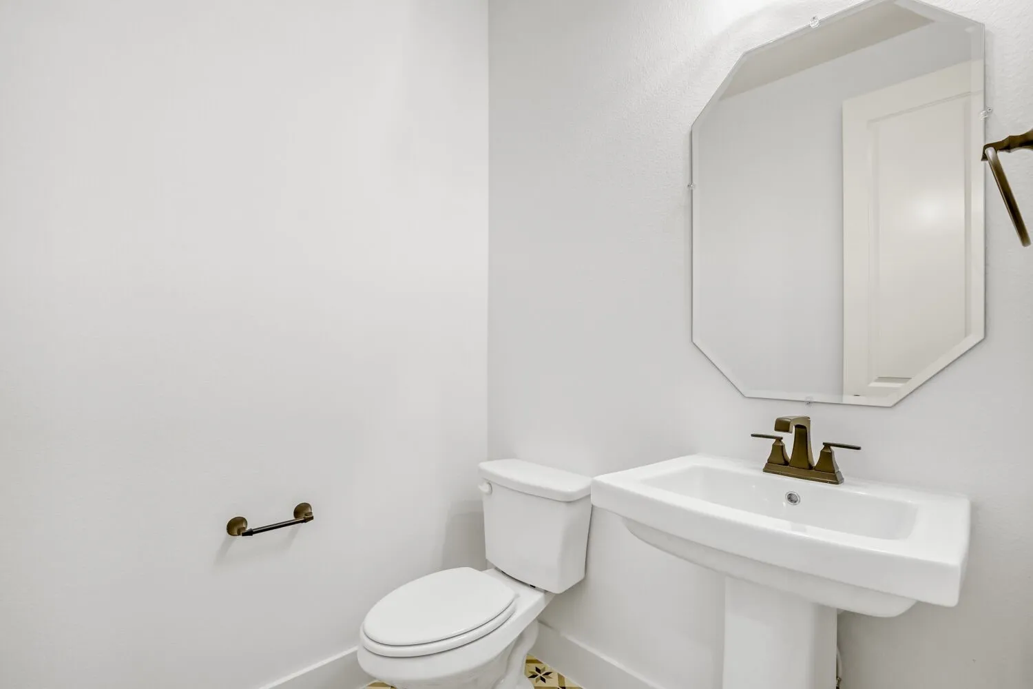 Half bathroom with toilet and baseboards