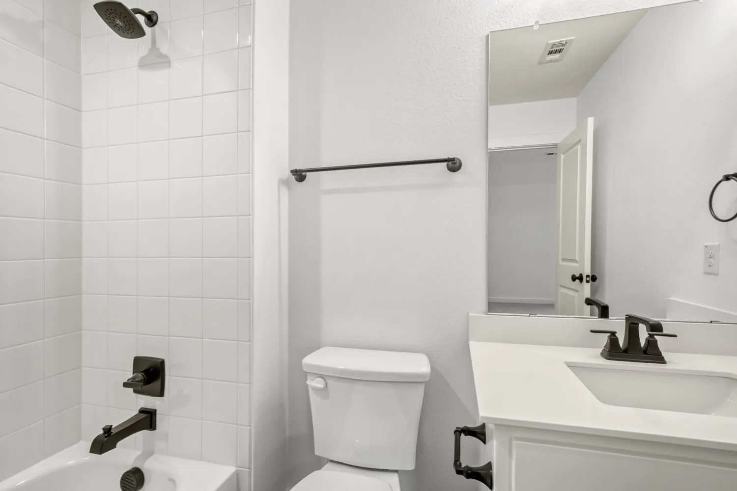 Bathroom featuring vanity and shower / bathtub combination