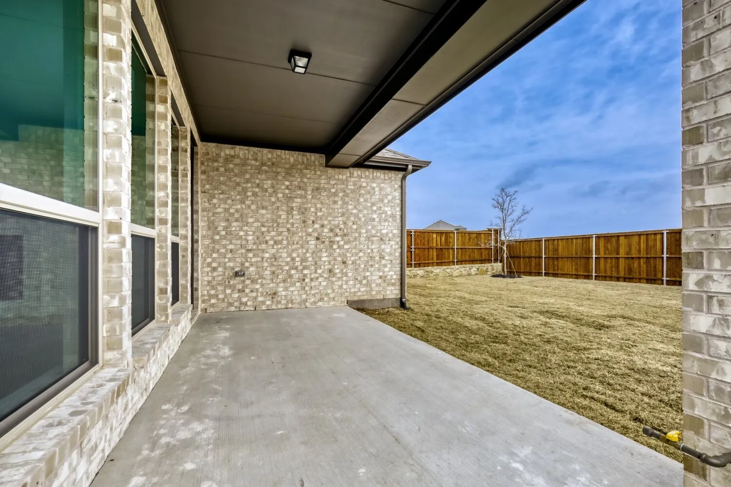 Fenced backyard with a patio area