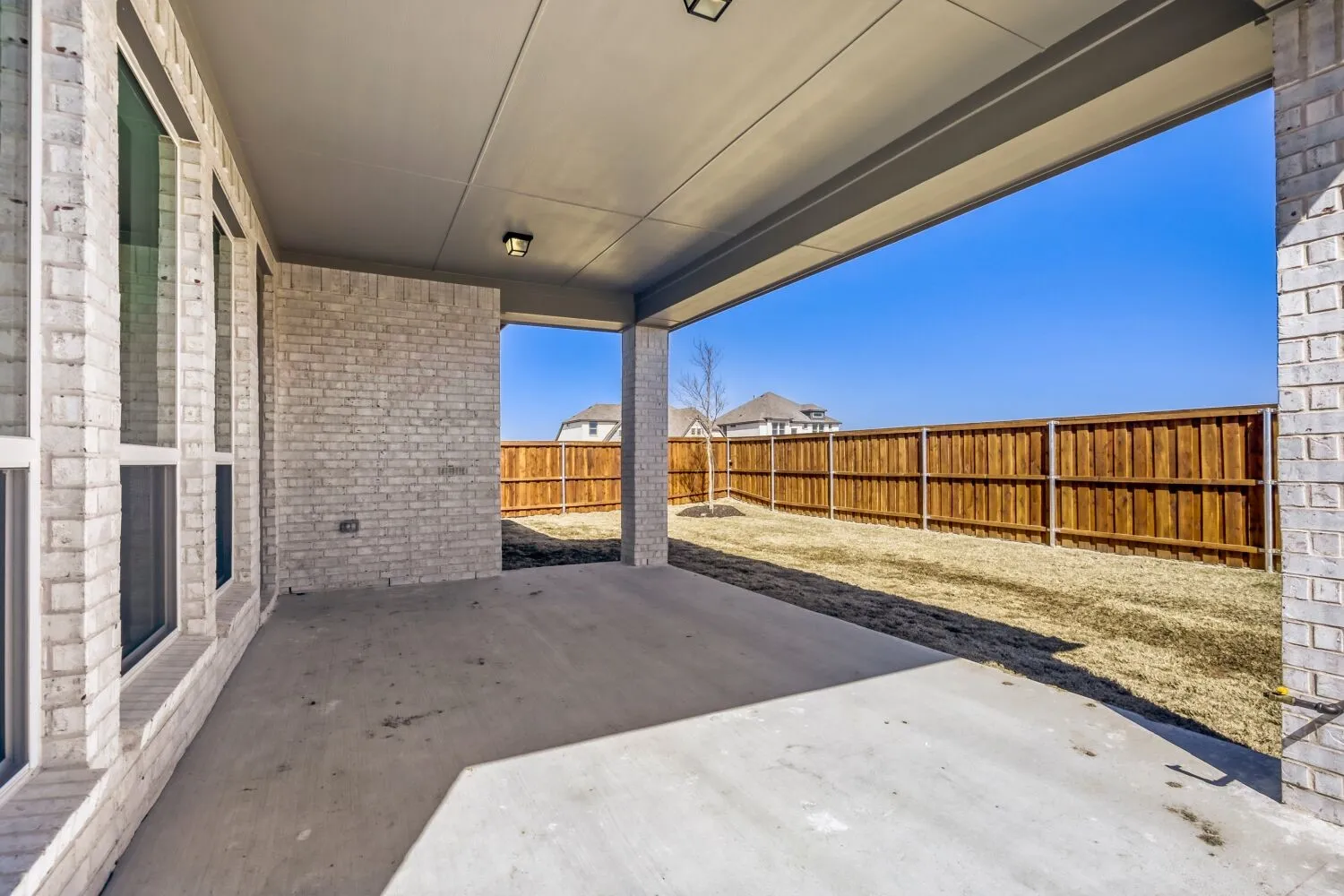 Fenced backyard featuring a patio