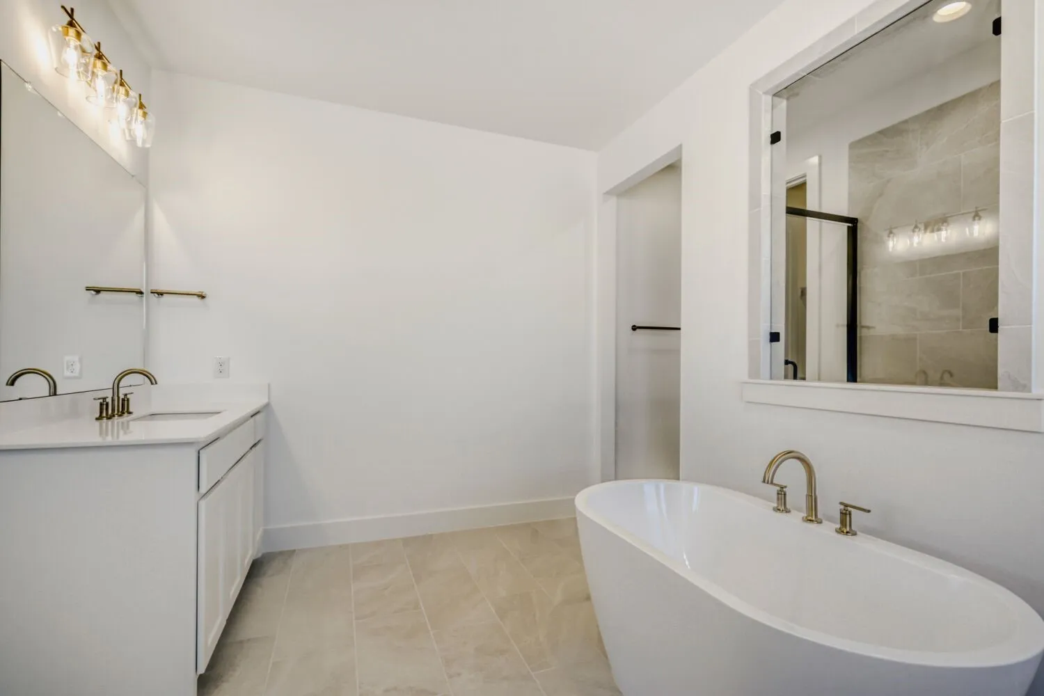 Full bath featuring vanity, a soaking tub, and a stall shower