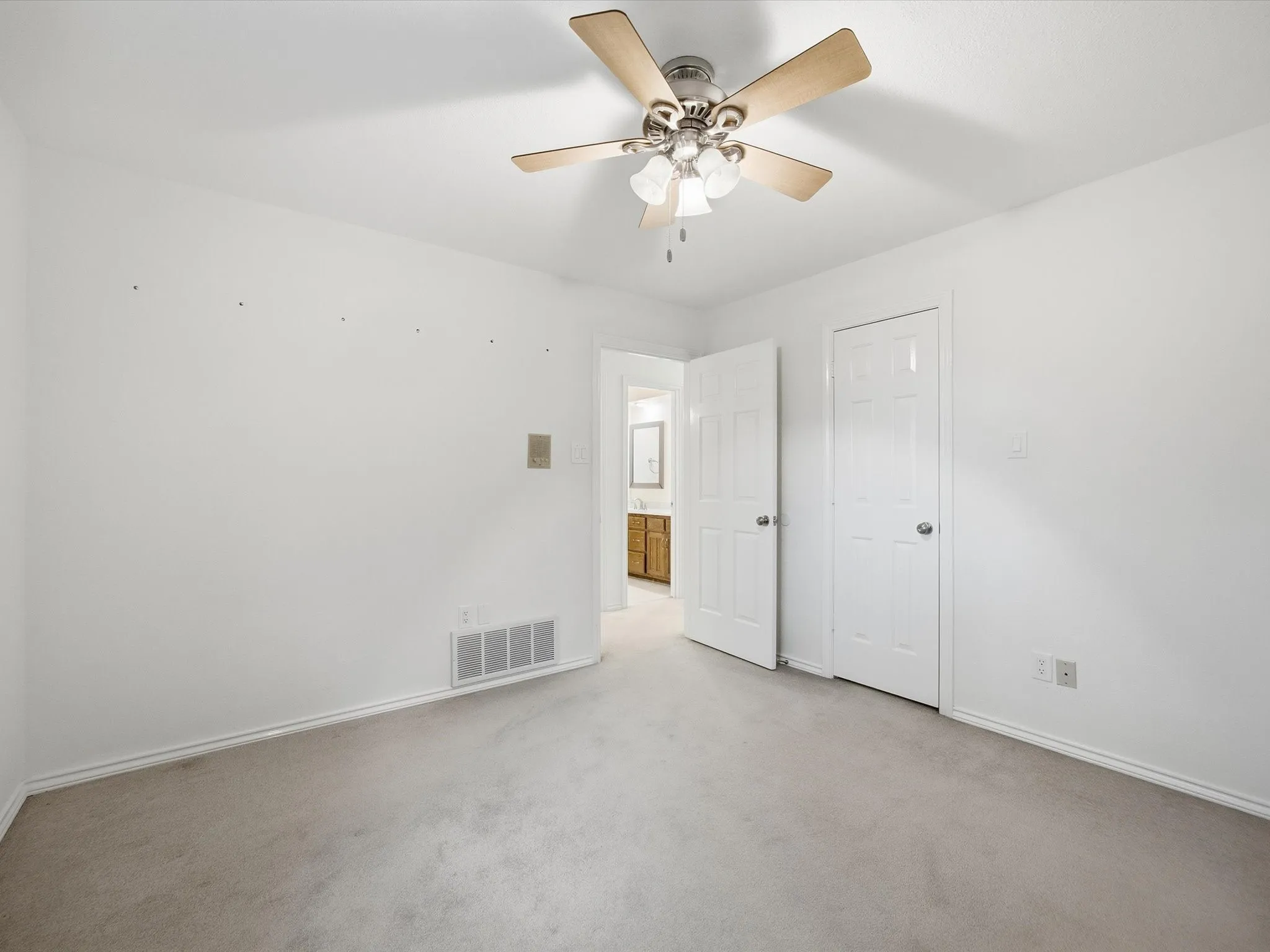 Unfurnished bedroom featuring carpet and ceiling fan