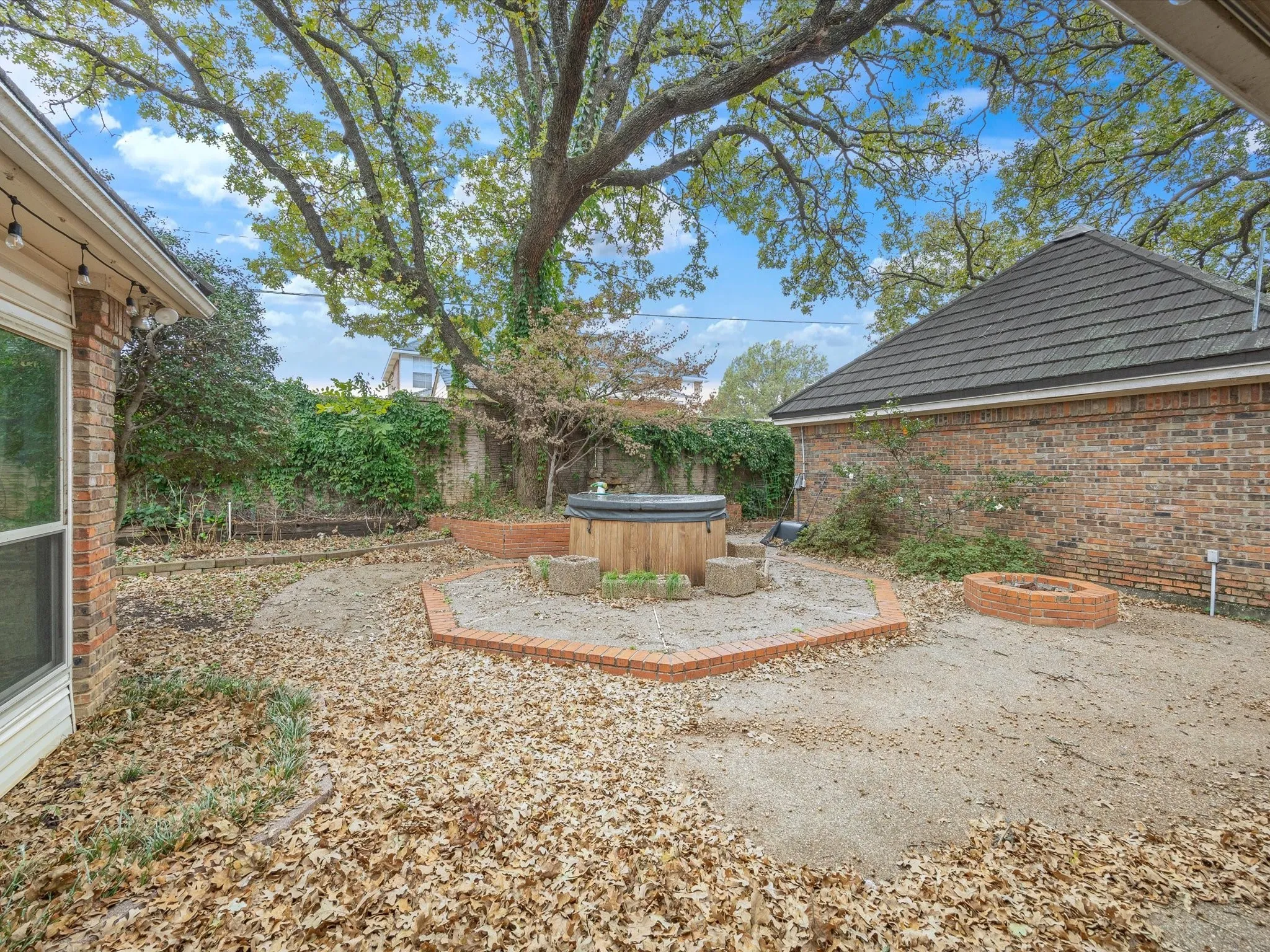View of yard with a hot tub and a patio