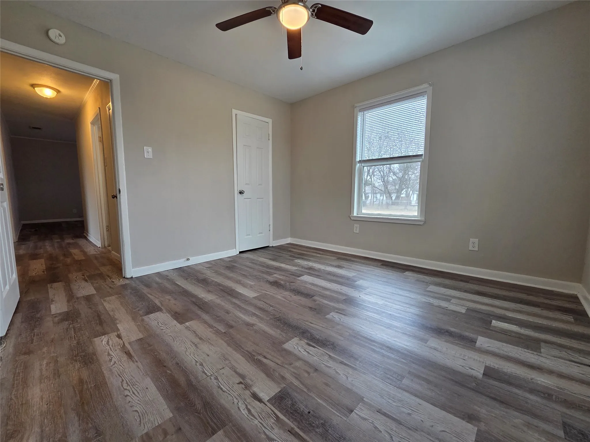 Unfurnished bedroom featuring wood finished floors and a ceiling fan