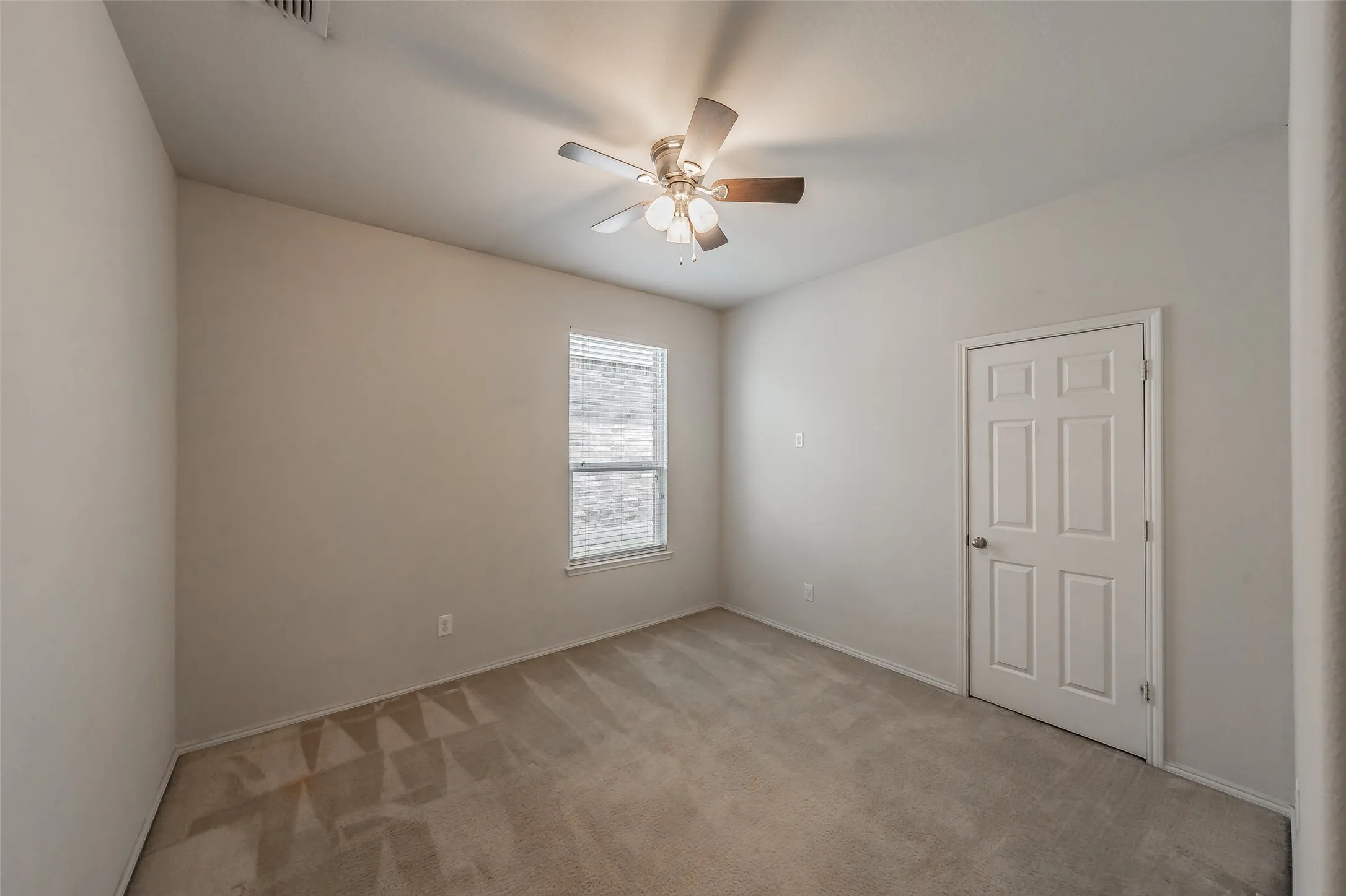 Neutral-toned room with carpeted flooring