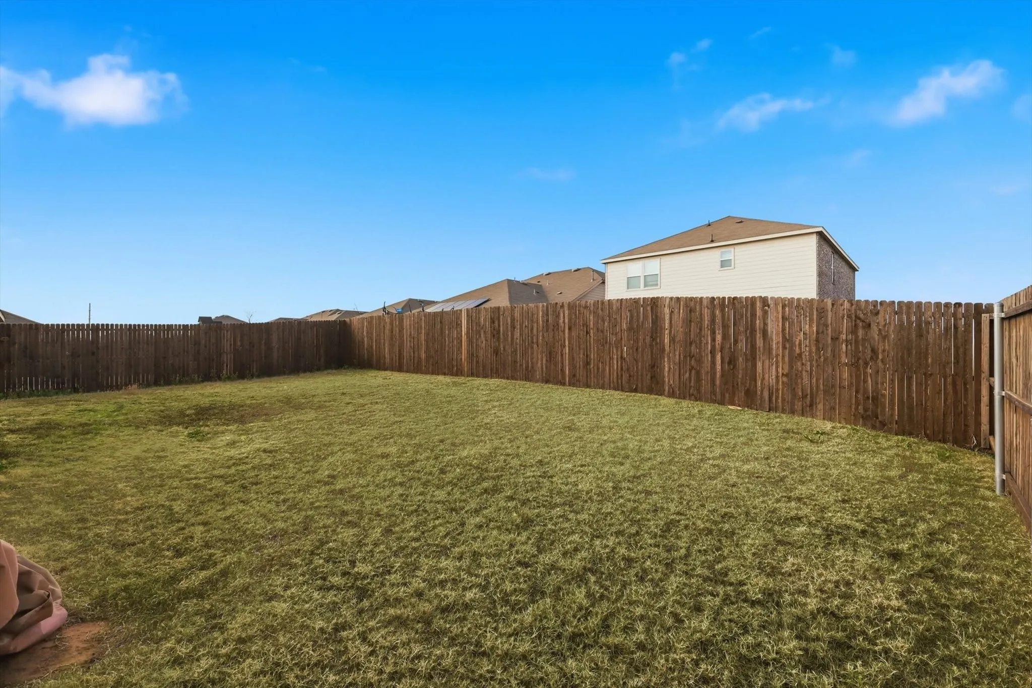 View of fenced backyard