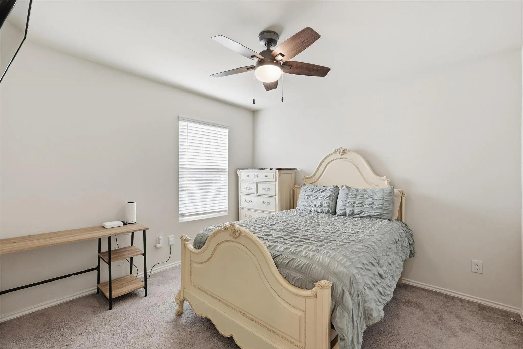 Bedroom featuring light carpet and ceiling fan
