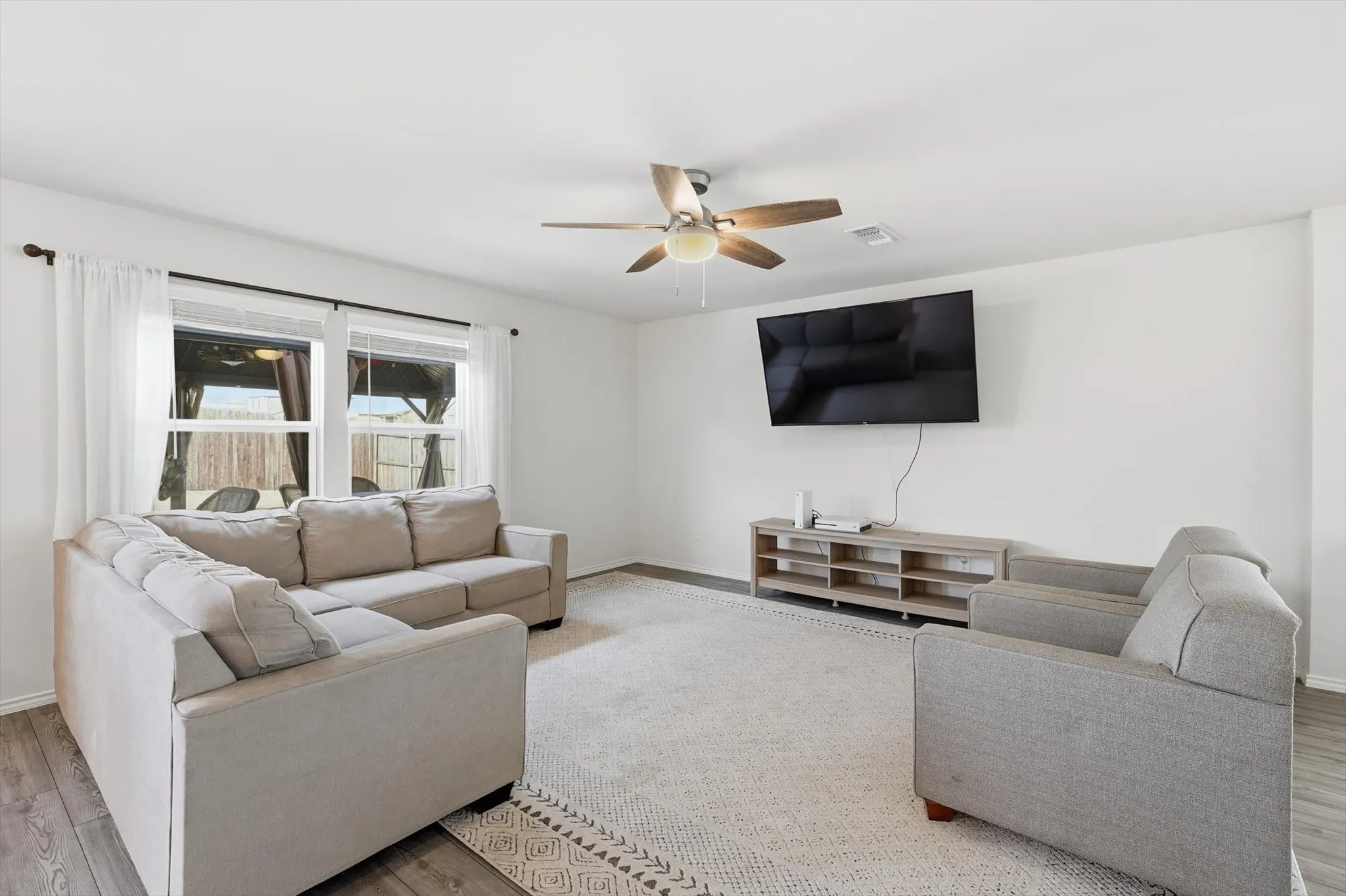 Living area featuring wood finished floors and ceiling fan