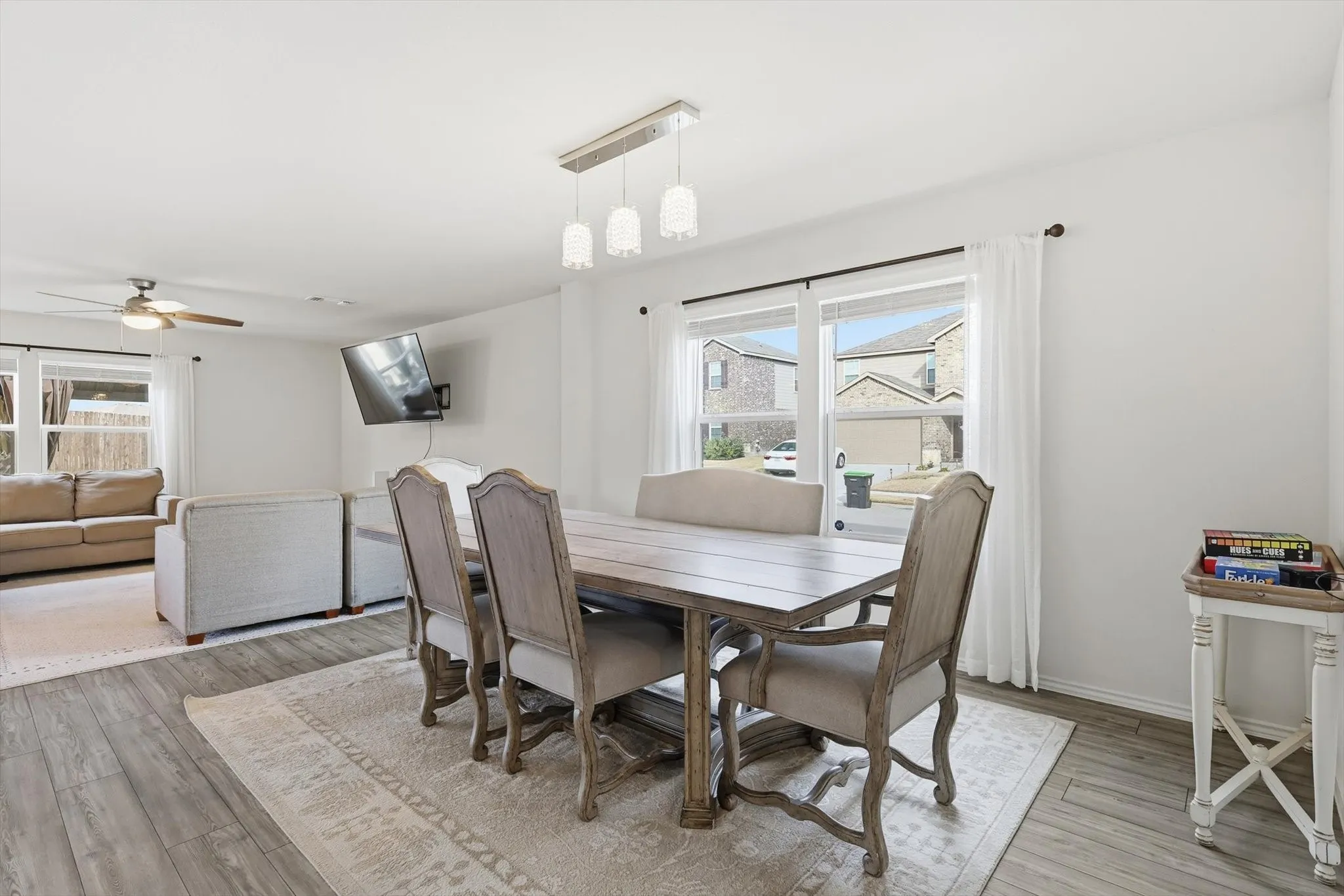 Dining area featuring healthy amount of natural light, light wood-type flooring, and a ceiling fan