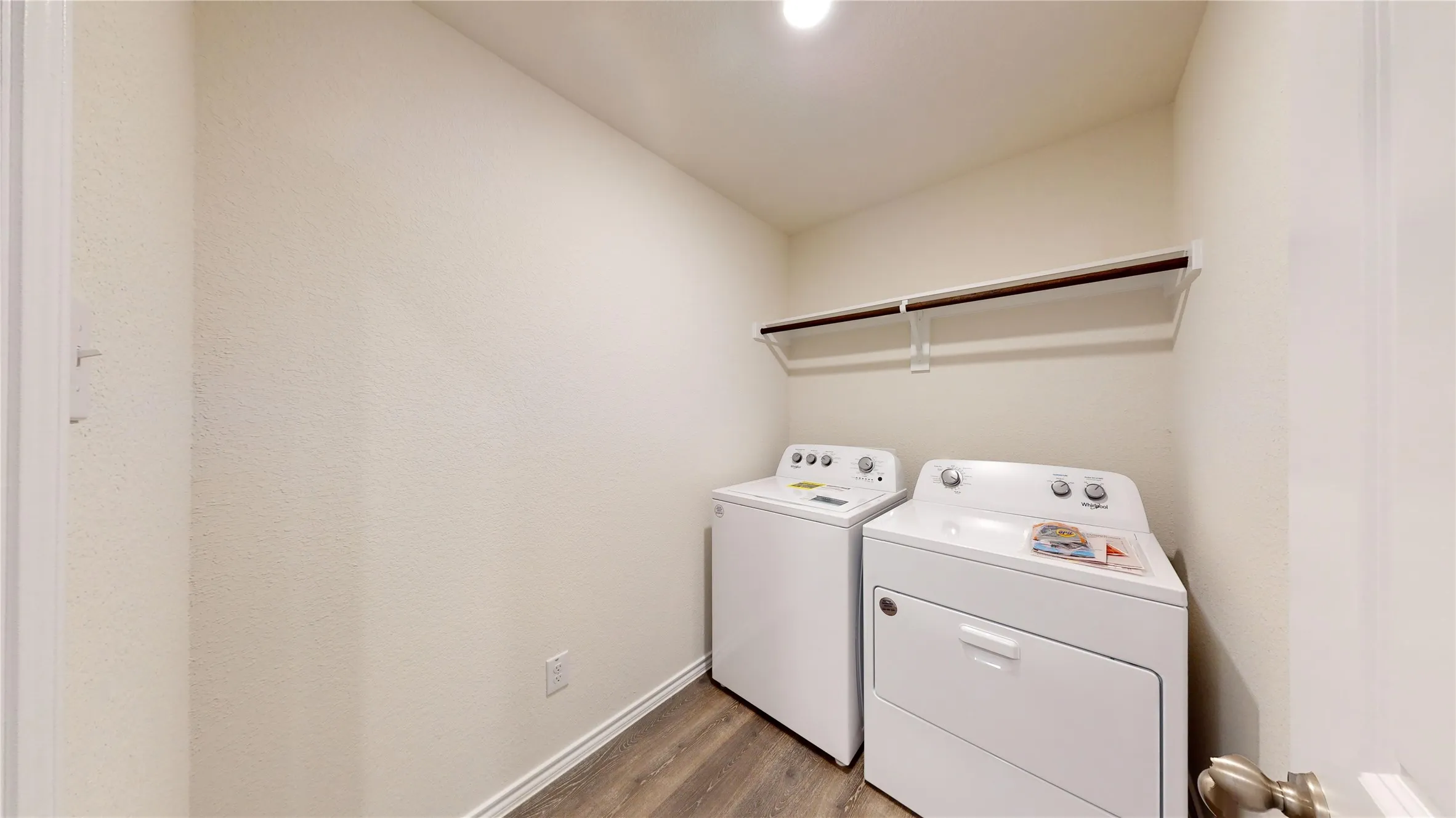 Washroom featuring dark wood-style flooring and separate washer and dryer