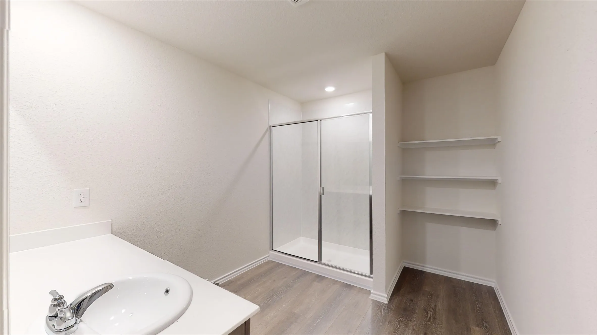 Full bathroom featuring vanity, a shower stall, dark wood-style flooring, and recessed lighting