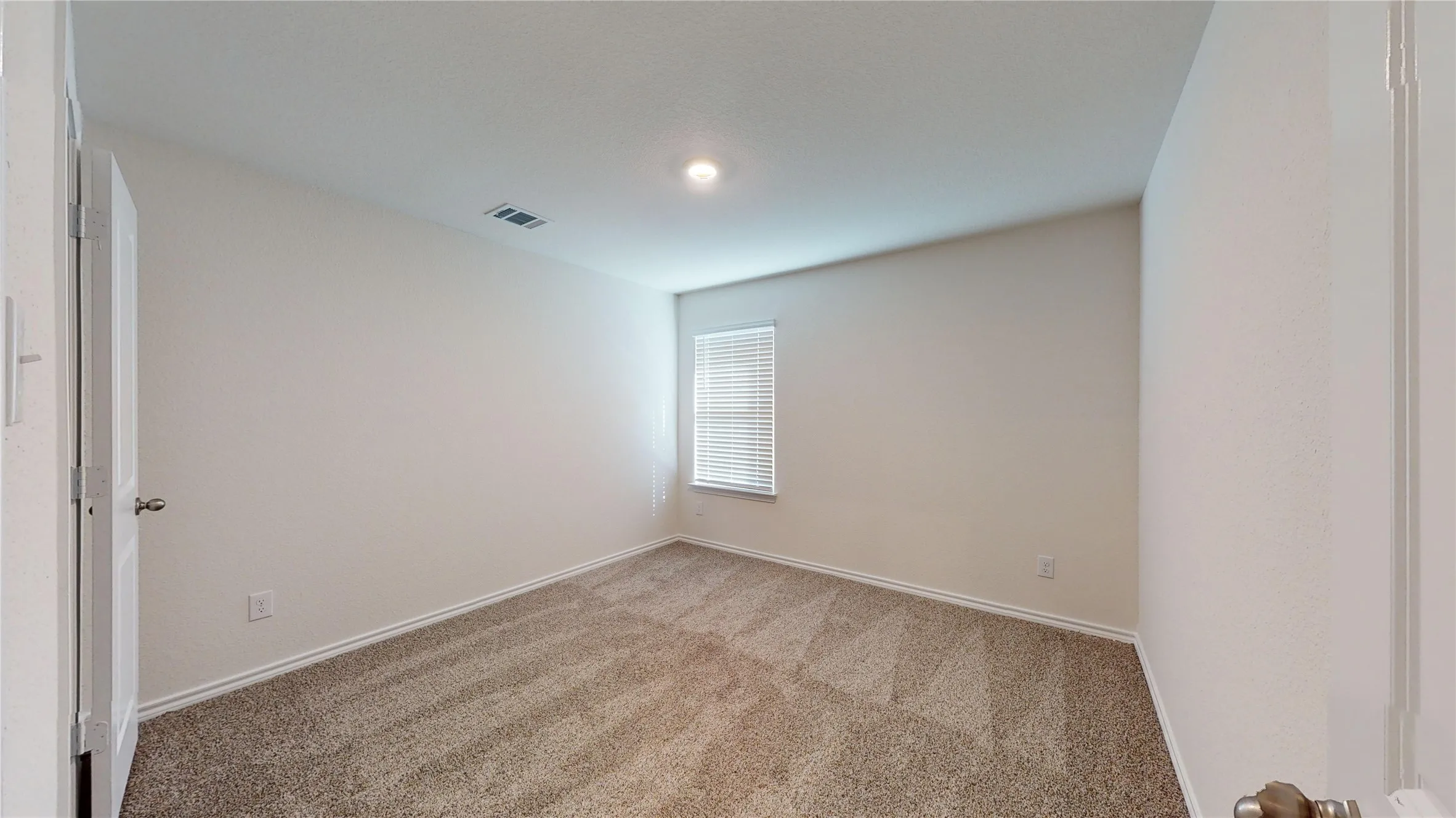 Carpeted empty room with baseboards