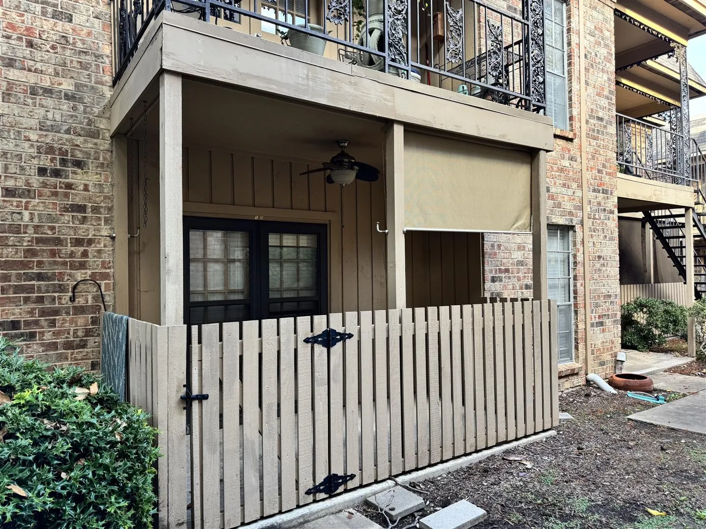 Entrance to property with brick siding and ceiling fan