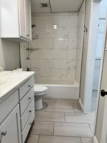 Full bath featuring shower / bath combination and vanity