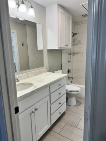 Full bathroom featuring vanity and shower / bath combination