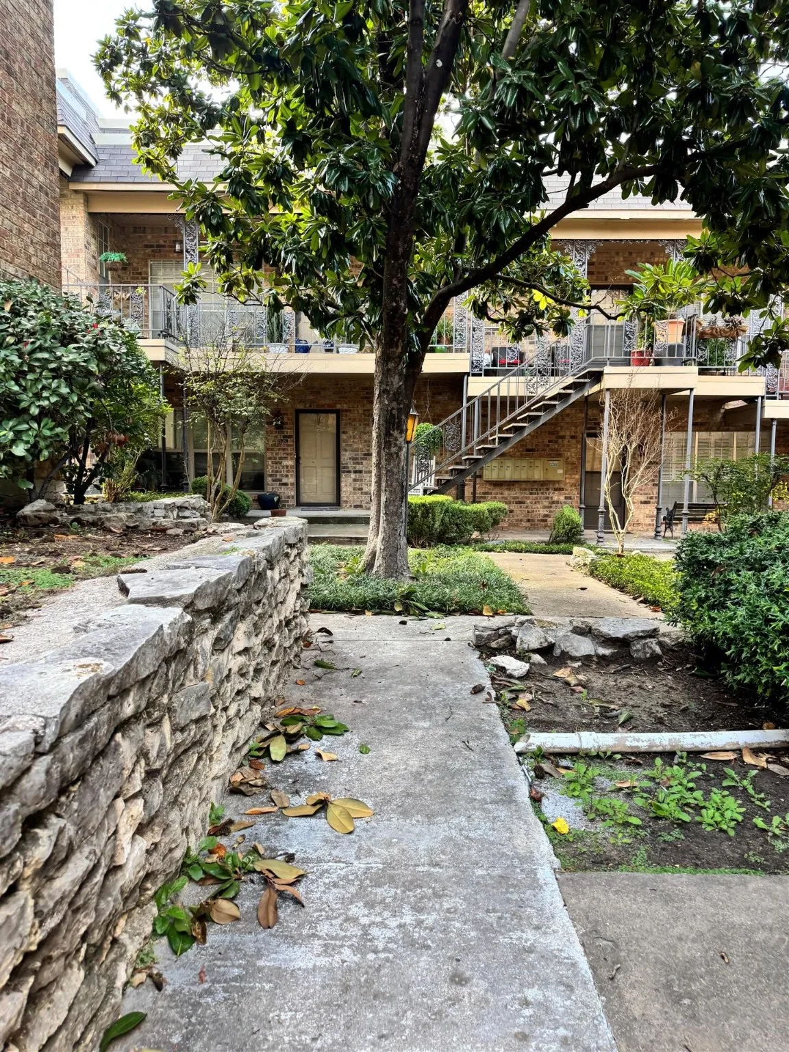 View of yard with a balcony and stairs