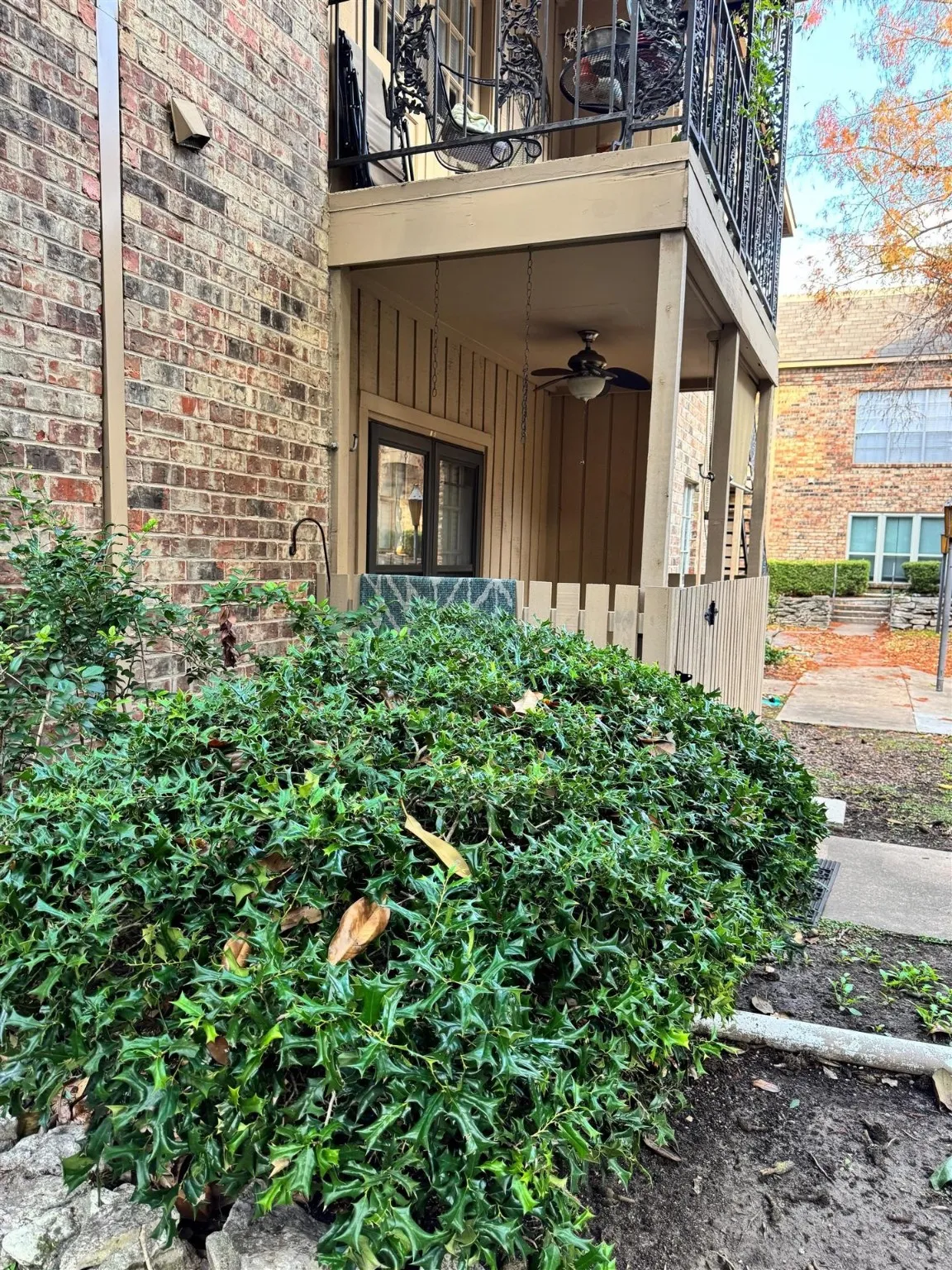 View of exterior entry with a ceiling fan and brick siding